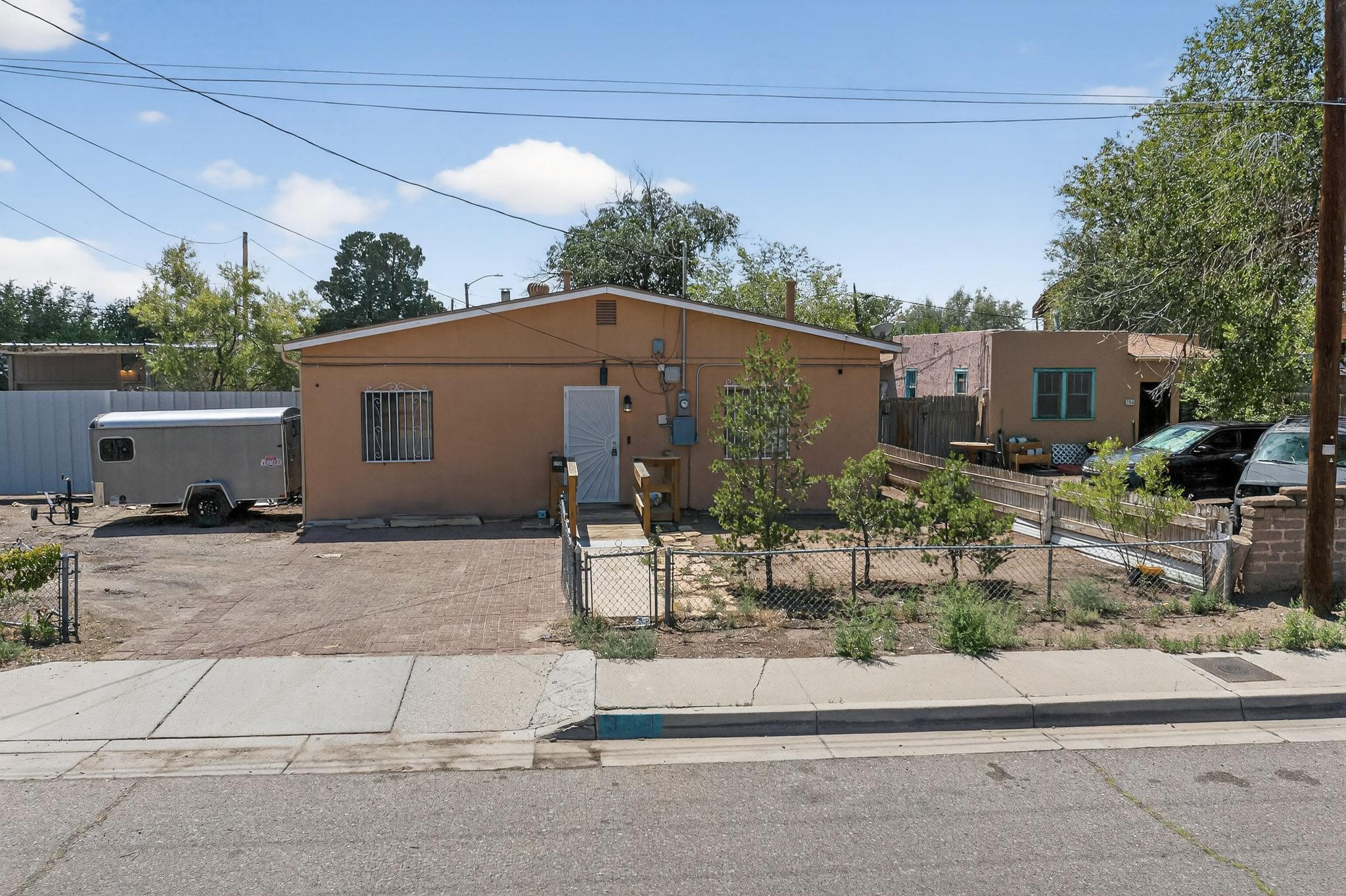 This spacious 3-bedroom, 2-bath home offers over 1,700 sq ft of comfortable living space and sits on a generous .22 acre lot.  Step inside to 2 living areas, a dining room, spacious bedrooms and huge laundry room. Entrance to home, living room, kitchen, primary bedroom/ bath, and laundry rooms are all handicap accessible. Car enthusiast or backyard mechanic? Enjoy the convenience of a 2-car garage plus a large carport, workshop/storage area, and secure fencing around the garage for added peace of mind. The open and covered back patio is perfect for relaxing or entertaining. New energy-efficient heat/cool mini splits ensure year-round comfort.
