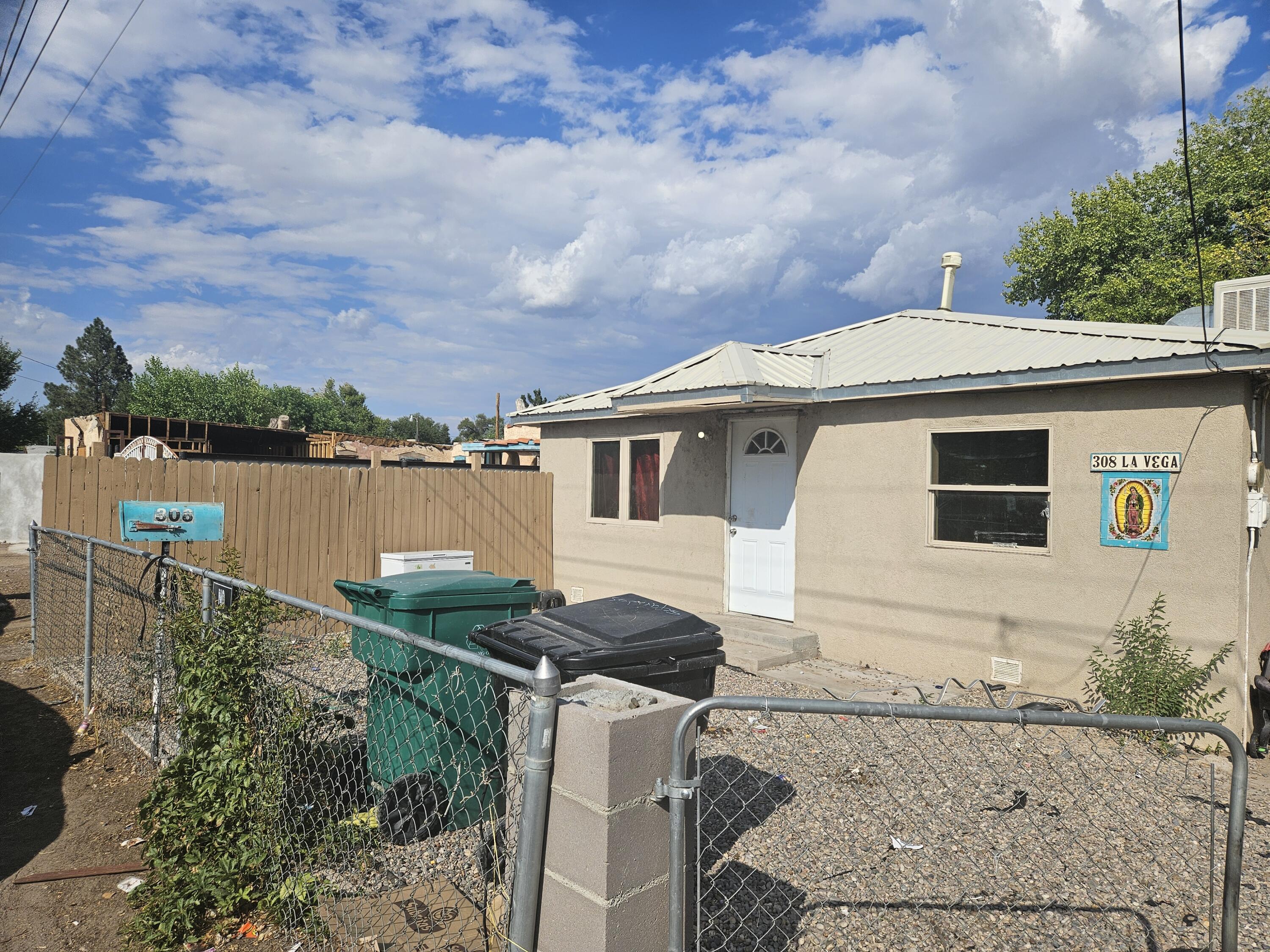 SO MUCH POTENTIIAL!! Main home with Casita!  Great Albuquerque area, close to convent stores, restaurants, recreation and not far from Rio Grand River. Home comes equipped with title floors and a metal roof. Lots of land and space for parking. Main home has 2 bed, 1 bath. Casita has additional room and bathroom plus kitchen. Come take look! Who knows it might be right for you!