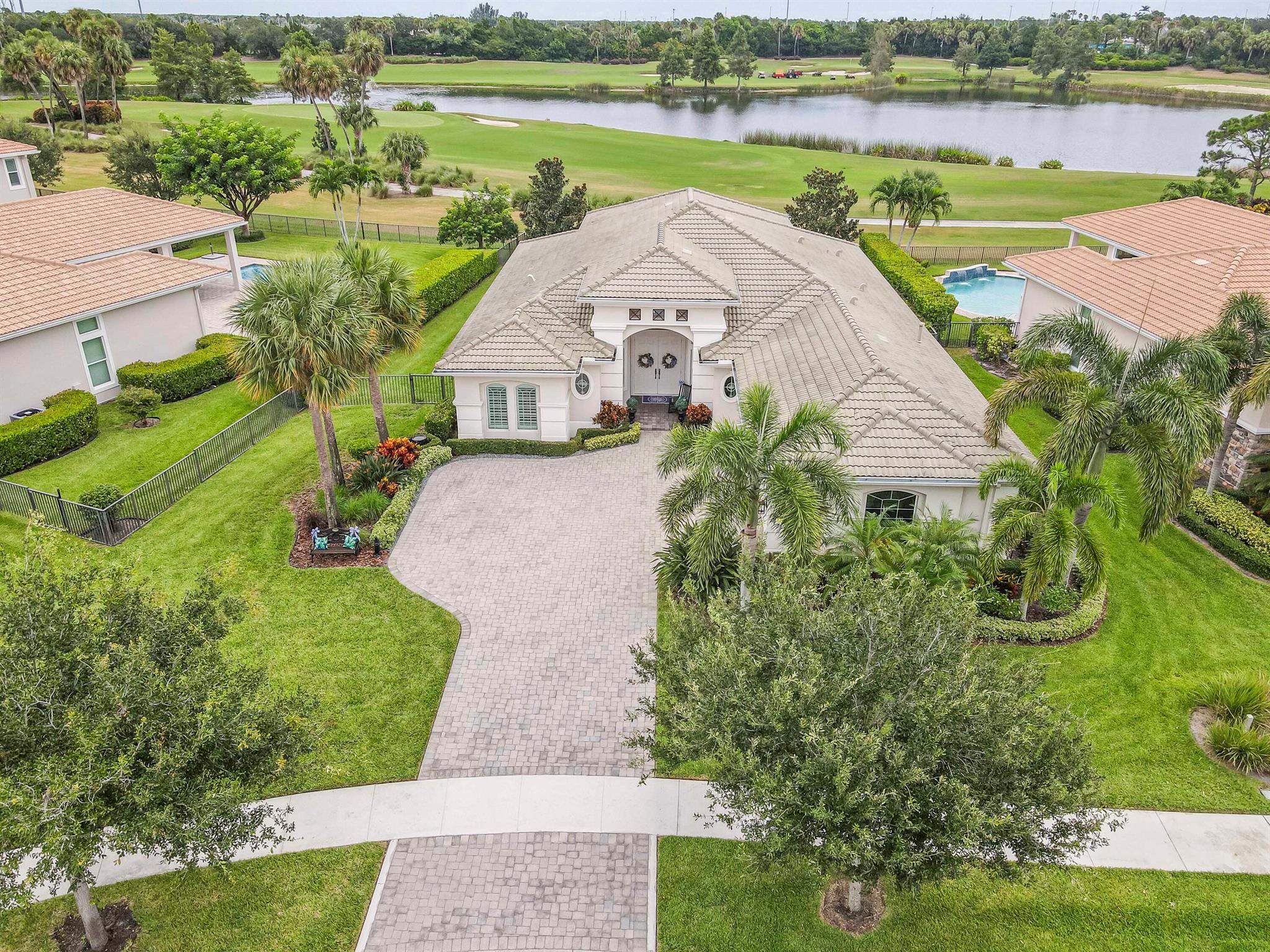 Live luxuriously & comfortably in this single-level Beaumont model with an ultra private homesite in the resort-style gated community of Jupiter Country Club. **FULL GOLF MEMBERSHIP is available immediately to the buyer of this home.** There is currently a long 3-5 year waitlist for this sought-after level of membership. (New owner can downgrade to social/club membership.) This home can be offered turnkey furnished-just bring your toothbrush! The open concept floor plan boasts 4 bedrooms, 3 1/2 baths, a flex room/den and a 3 CAR GARAGE. Privacy abounds from this prime location offering sweeping lake, fountain, golf course & tree-lined views with no homes in the rear. Oversized reverse-pie shaped corner lot with an enormous side yard. This home is beautifully appointed and provides all the essentials of easy Florida living with impact glass windows, solid CBS construction &amp; natural gas. Gorgeous designer upgrades include white oak hardwood flooring, plantation shutters, custom closets, built-in drop zone &amp; stylish light fixtures. Immerse yourself in the ultimate outdoor oasis with a summer kitchen and an expansive saltwater heated private pool &amp; spa surrounded by travertine pavers and lush tropical landscaping. The pool area was completely revamped with a new pebble pool finish, a large sunshelf, and a relaxing spa with a custom waterfall feature. Relish the colorful sunsets and the panoramic views from the covered patio or pool deck. Gather in the open concept great room offering lovely views of the turquoise pool, lake &amp; golf course. Loads of natural light flows into the home through the large impact sliders and transom windows. Channel your inner chef in the kitchen featuring an expansive center island with seating, dual-temperature wine refrigerator, 5 burner gas cooktop, dual wall ovens and granite countertops. The primary suite is truly a retreat featuring two walk-in closets with built-ins and a spa-like primary bath with dual vanities, a large soaking tub, and walk-in shower with frameless glass enclosure &amp; river rock flooring. Your guests will rest comfortably in the 3 spacious guest bedrooms. One is adjacent to the full cabana bath. The other 2 share a Jack-n-Jill bath. A separate powder room for guests is located near the flex room. The flex room/den is perfect as an office, media room, exercise room or a convertible 5th bedroom. Jupiter Country Club is a luxury gated community conveniently located within close proximity of I-95 and the FL Turnpike, pristine beaches, world-class shopping, restaurants, parks &amp; nature preserves. Club amenities &amp; events offer a plethora of social opportunities and include a Greg Norman Signature 18 hole golf course, 2 resort-style pools, the Sway restaurant &amp; bar, a state-of-the-art fitness center + pilates reformer, yoga, barre (&amp; many more) group fitness classes, massage/facial treatment services, tennis, bocce ball, pickleball &amp; basketball. Members enjoy reciprocal privileges to Invited Clubs worldwide. Live your best life here!