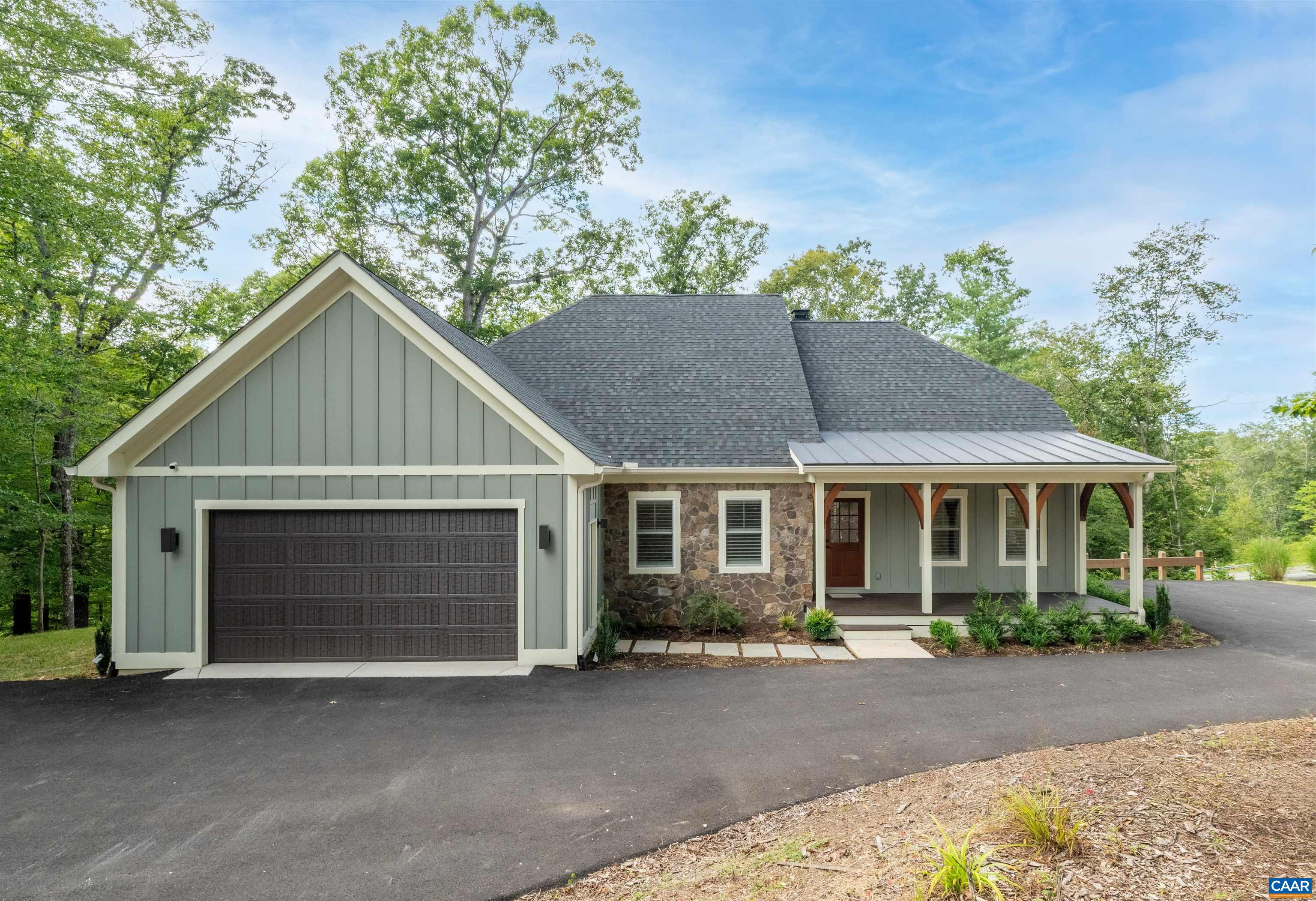 Come check out this 2023 European Homes masterpiece, a residence that perfectly balances sophistication, comfort, and convenience. Thoughtfully customized, this 5 bedroom, 4.5 bath, 4,600 sq. ft. home is nestled on 1.5 wooded acres—just minutes from UVA, Downtown Charlottesville, dining, and shopping—yet it feels like a private retreat.  This home features hardwood floors throughout the home, a chef’s kitchen with quartz countertops and stainless steel appliances, and an open-concept living area with a gas fireplace. Step onto the screened porch to enjoy serene wooded views or relax in the elegant primary suite featuring a spa-like bath with marble finishes.  The fully finished terrace level offers versatile living, complete with two additional rooms perfect for a home office, gym, or media space. Outdoor living is at its best with a custom stone outdoor gas fireplace, hot tub, and patio designed for relaxing and unwinding.  Built with exceptional quality and care by Massimo Rampini of European Homes, this residence exemplifies refined craftsmanship, blending timeless design with modern comforts.
