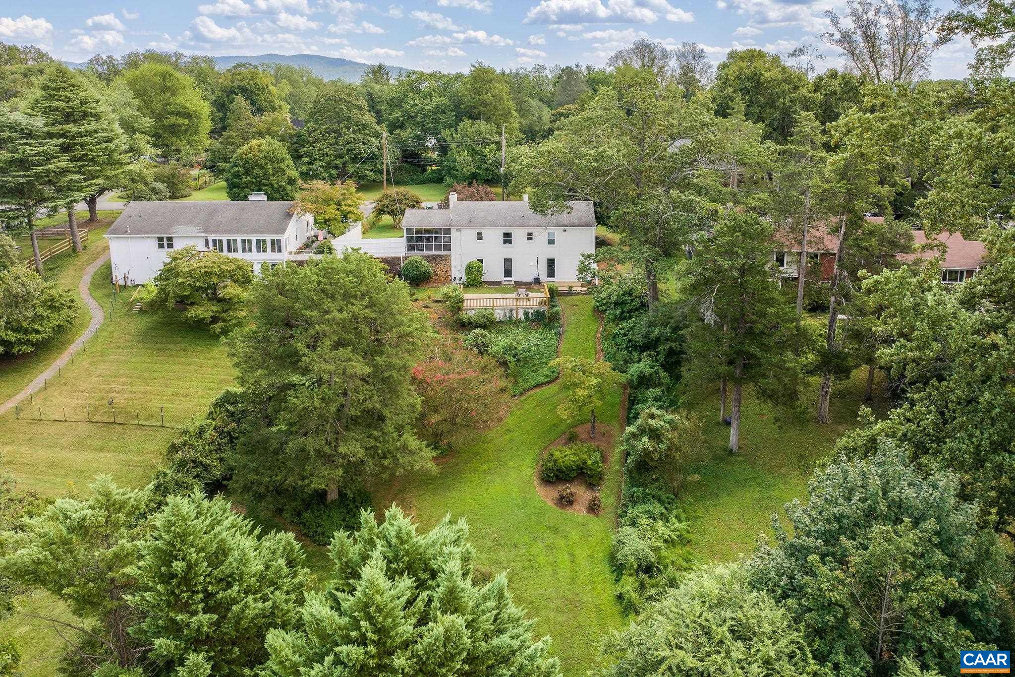 Charming from the first glance, this one-level painted brick home with three bedrooms on an incredible park-like, half-acre lot in desirable Meadowbrook Heights. On the coveted, quiet Saint Annes Rd, the yard is truly a park-like setting in this city location.  Refinished original narrow width hardwood white oak floors, two wood-burning fireplaces, a renovated bright-white kitchen and two refreshed full baths on the interior. The mostly-finished walk-out basement with lots of windows offers a family room, full bath, laundry room, storage, and workshop. Right off the kitchen is a large screened patio that overlooks the rear yard.  The beautifully landscaped yard is filled with perennials, mature flowering trees & shrubs, and has so many options for usage of this incredible setting. Conveniently located near UVA, schools, shopping, and downtown.  Furnace (2022), AC (2019), Water Heater (2019), Windows (Upstairs 2006, Basement 2016), Gas Fireplace insert (2022), Exterior freshly painted (2025)