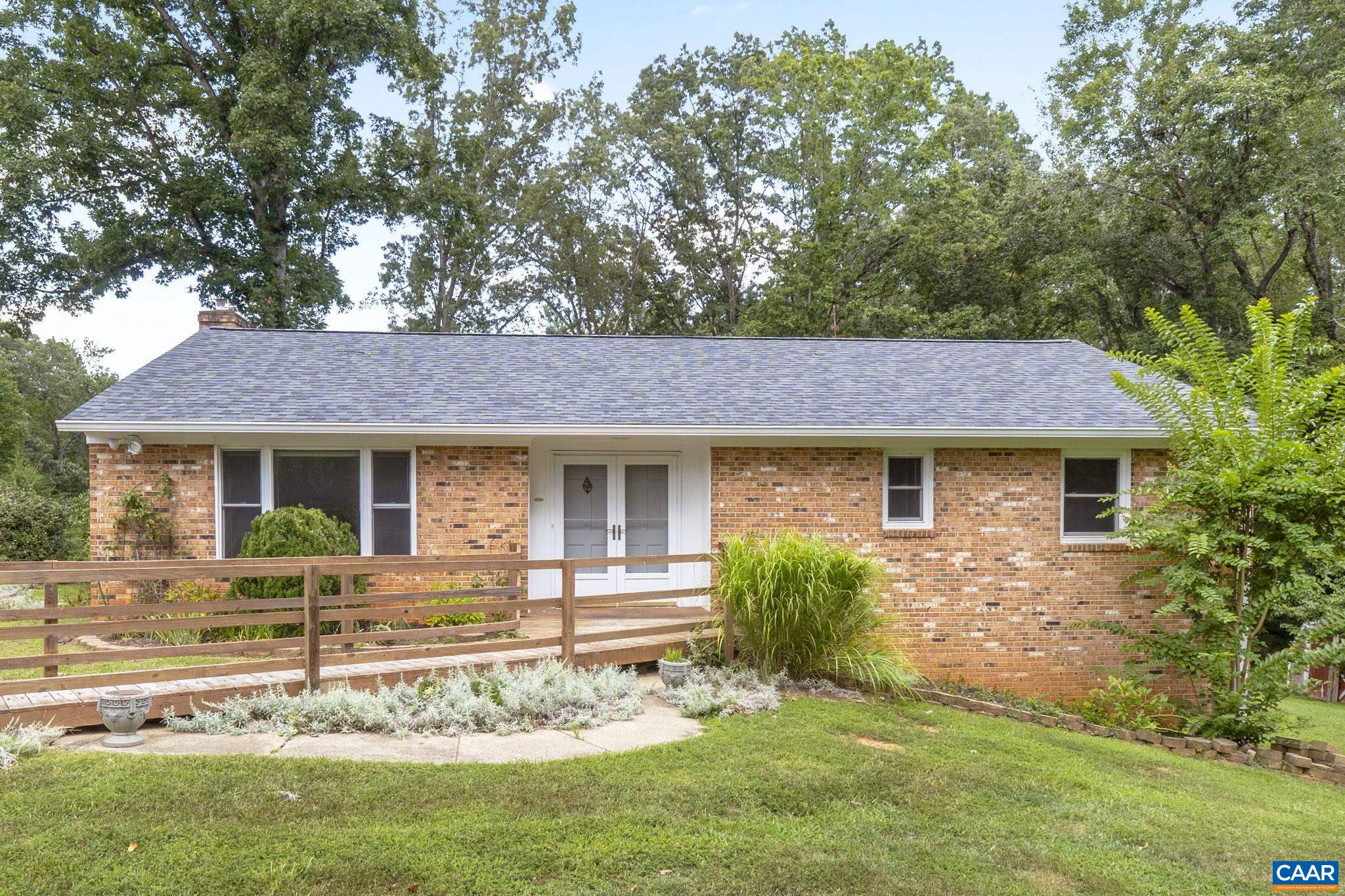 RARE Find in Earlysville Heights! This beautifully maintained 4-bedroom, 3-bath brick ranch sits on a quiet street in one of Northern Albemarle’s most desirable neighborhoods—just minutes to the airport, Hollymead Town Center, Ivy Creek trails, NGIC, and only 15 minutes to Charlottesville. Light-filled and move-in ready, the home offers hardwood floors throughout the main level, a spacious living room, dining room with fireplace, and three main-level bedrooms with two full baths. The terrace level features a large rec room with wood stove, full bath, and a versatile 4th bedroom/office. Major updates give peace of mind: new roof (2024), French drain (2024), exterior paint (2023), dishwasher (2025), new well (2020), HVAC (2017), replaced windows (2005), plus partial generator. With 0.6 acres, no HOA, and a quiet, established community, this Earlysville gem offers both comfort and convenience in a rare location.