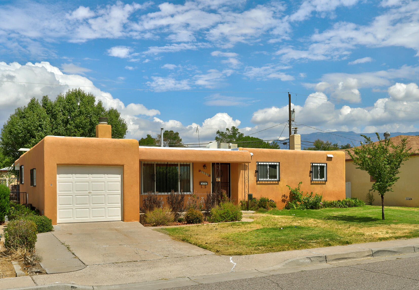 Beautifully maintained single-level home in the NE Heights (Snow Heights). This 3-bedroom, 2-bath property features updated windows, a spacious living area with wood-burning fireplace, formal dining, & a nice sized laundry room. The kitchen is equipped with granite countertops, abundant cabinetry, & newer stainless steel appliances. The primary suite offers a walk-in closet, sitting area with wood burning fireplace, & built-in bookcases. Outdoor living includes an expansive front porch, a large covered backyard patio-perfect for entertaining, and a one-car garage. Front & back are fully landscaped. Come see it today! Home is priced to accommodate an ''as is'' sale. Seller will not make any repairs.