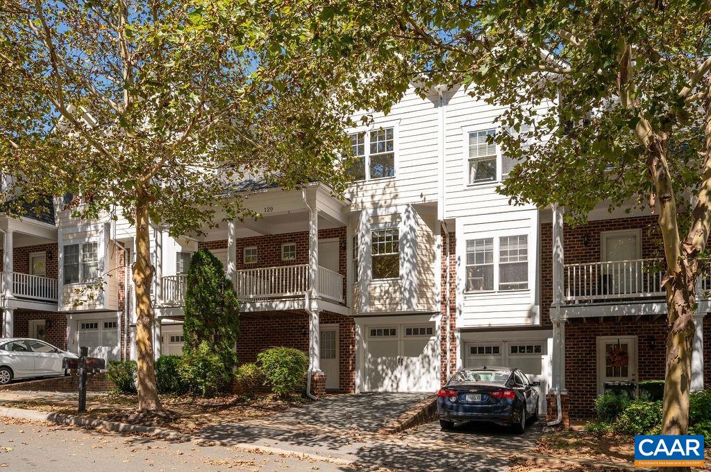 Fresh and bright 4-bedroom townhome with an unbeatable location. Just a short drive or easy bike ride from UVA and downtown, with convenient access to I-64, and within walking distance to a city bus line stop and the local elementary school as well as 5th Street Station, home to Wegmans, various retail stores and restaurants, and the Alamo Cinema Drafthouse. This home is completely ready for its next owner, featuring hardwood floors throughout the main level, newly replaced carpet in all bedrooms, and fresh paint throughout. The inviting family room, complete with a gas fireplace and access to one of two rear decks, is perfectly situated adjacent to the kitchen, making it ideal for gatherings. The main level also includes a dining room, a convenient half bath, and a spacious living room that opens to a front porch. Upstairs, you'll find two bedrooms, a full bath, and a stackable full-sized laundry. The primary suite, also on this level, boasts lovely morning light, a full bath, and a walk-in closet. The fourth bedroom on the lowest level allows for versatile options and is currently used as a bonus room, with a nearby half bath and access to the lower deck. Never worry about parking with your own private driveway and garage.