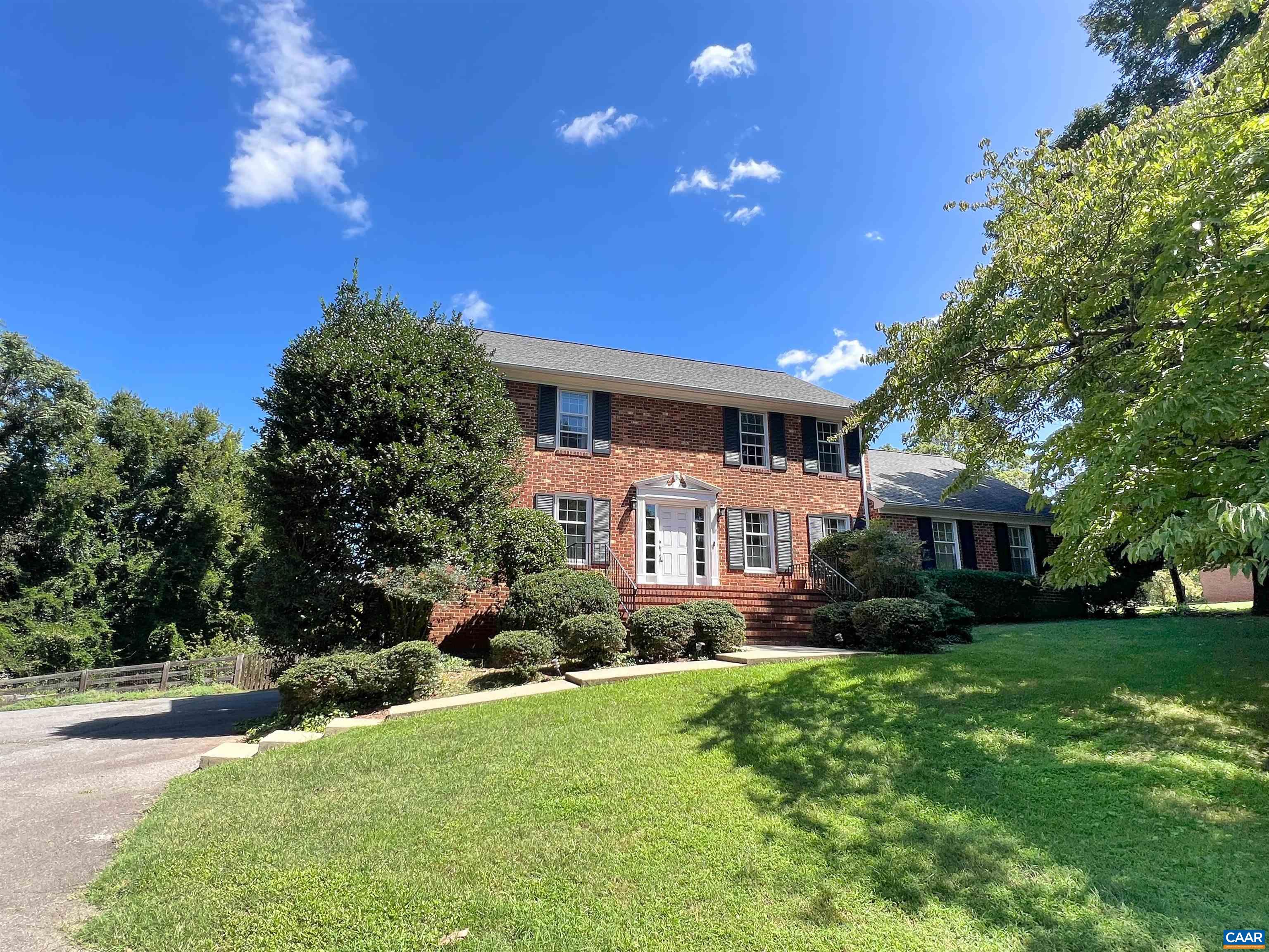 Welcome home to this classic brick colonial on a beautifully landscaped 3/4-acre lot with mature trees and a fully fenced backyard. Enjoy outdoor living on the oversized deck, perfect for entertaining! Inside, you'll find freshly refinished hardwood floors, a cozy family room with wood-burning fireplace, formal living and dining rooms, and an updated kitchen with solid surface counters, newer appliances, and wood cabinetry. The main level offers two bedrooms and a full plus half bath, ideal for one-level living. A spacious mudroom leads to a walk-in pantry and laundry area. Upstairs are three generously sized bedrooms and two full baths- the primary bath has been fully renovated with new tile and a walk-in shower. The unfinished basement offers great storage potential, and the encapsulated crawl space is clean and dry. Roof was replaced in 2015 and the septic system was replaced recently with an extensive system that eliminates the need to dig up the yard for future maintenance. Move-in ready with room to make it your own!
