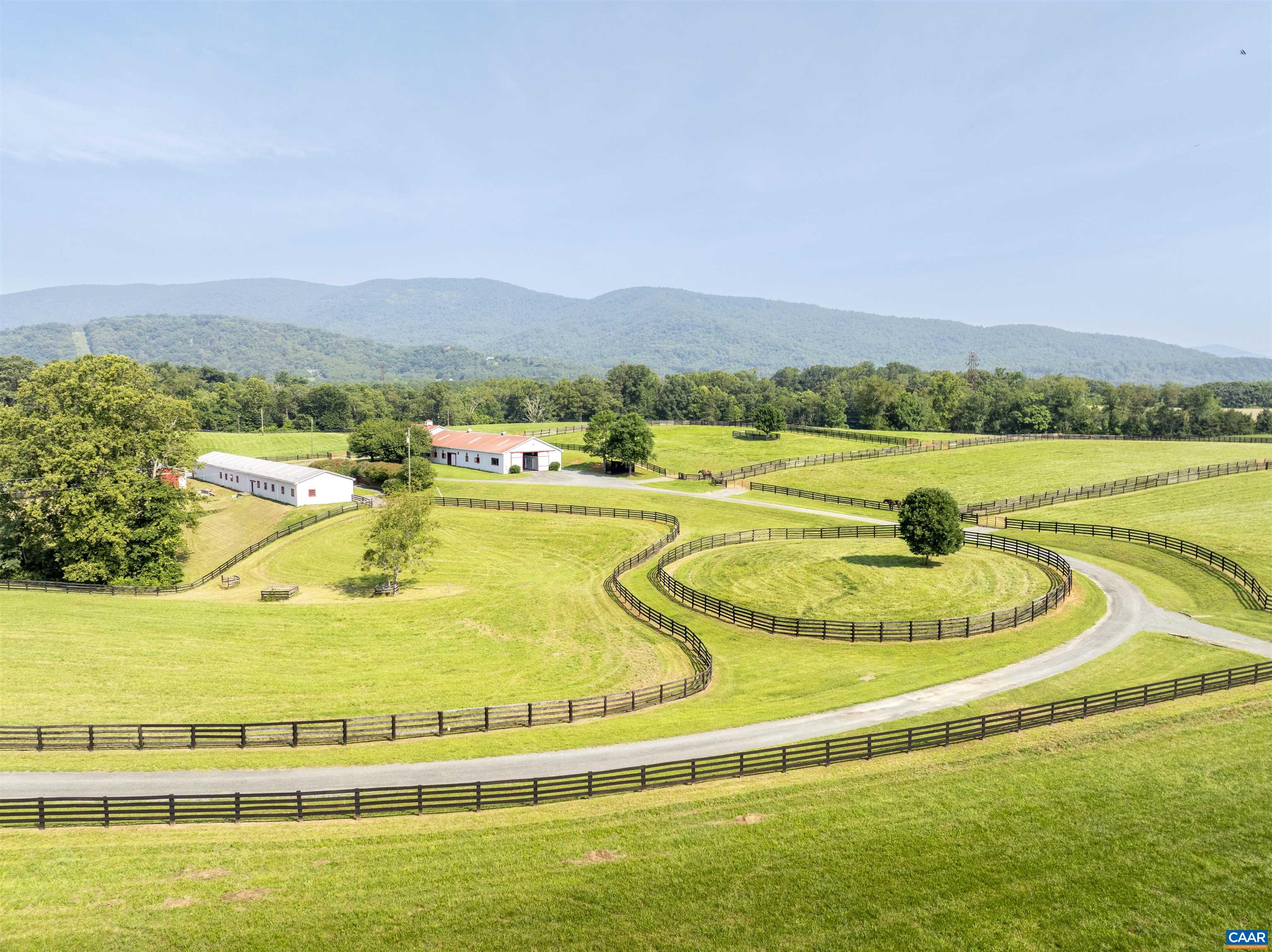 A storied, 111-acre farm with brick manor home offering complete privacy, natural beauty and grand Blue Ridge views. This rare offering sits on the edge of Crozet with easy access to all its amenities. The 7,700 square foot residence was designed by renown architect Sandy H. Lambert, III, AIA and is well-sited on the back of the property offering complete privacy and expansive mountain views to the West.  The home offers 10 ft ceilings, well-proportioned rooms, a large family room/kitchen, wide plank floors, and heart pine millwork and doors. 60 acres of rolling, productive pasture, and the balance in hardwoods.  Two streams traverse this well-watered property and feed the nearby reservoir.  Good farm infrastructure including two stables in good condition, road system and 4-board fencing. Not in conservation easement. PLEASE DO NOT DRIVE-BY OUT OF CONSIDERATION FOR NEIGHBORING HORSE OPERATION.