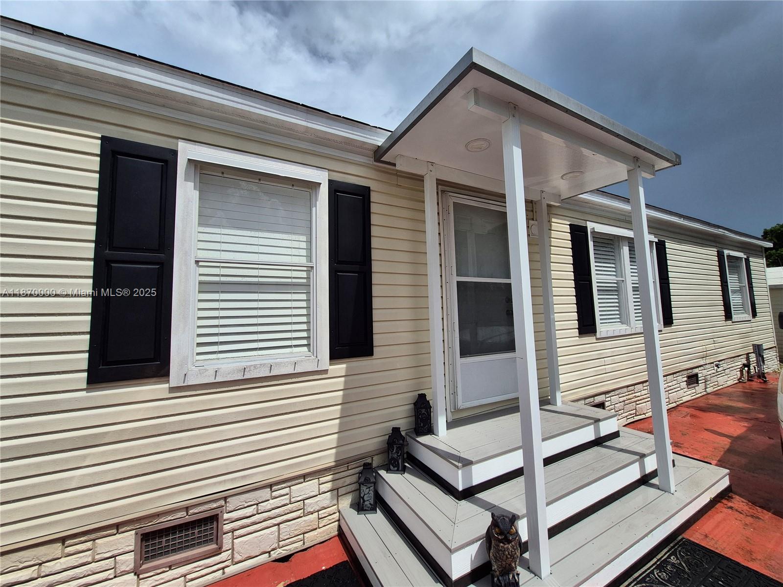 Beautiful manufactured home with land. 3 bedrooms, 3 bathrooms in gated community. Remodeled kithcen, floors and one of the bathrooms was remodeled. Fenced large yard, with patio, great for outside entertaining. Has 2 sheds, community pool. Close to shopping centers, restaurants, businesses ans good schools. Near the Turnpike, US1 and within 25 minutes of the entrance to the Florida Keyes.