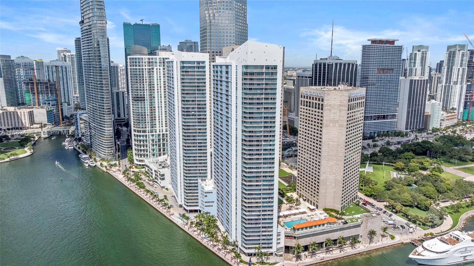 Experience elevated living on the 19th floor with great breathtaking views of Biscayne Bay, Bayfront Park, and the Miami skyline. This elegant one bedroom one bath condo features rich wood laminate floors, kitchen with ceramic tile, stainless steel appliances & granite countertops. Thoughtful built-ins include a custom media console, a walk in closet, & wall cabinetry in the bedroom that serves as a sleek, built in dresser. The unit includes a washer & dryer for added convenience. Residents enjoy resort style amenities: 2 sparkling pools, spa, sauna, valet, welcome lobby, and a convenient store on site. Just minutes to Sobe, Coconut Grove, Coral Cables, Key Biscayne, the Design District & Miami International Airport. IL Gambiano on site, posh Italian dining with waterfront terrace!