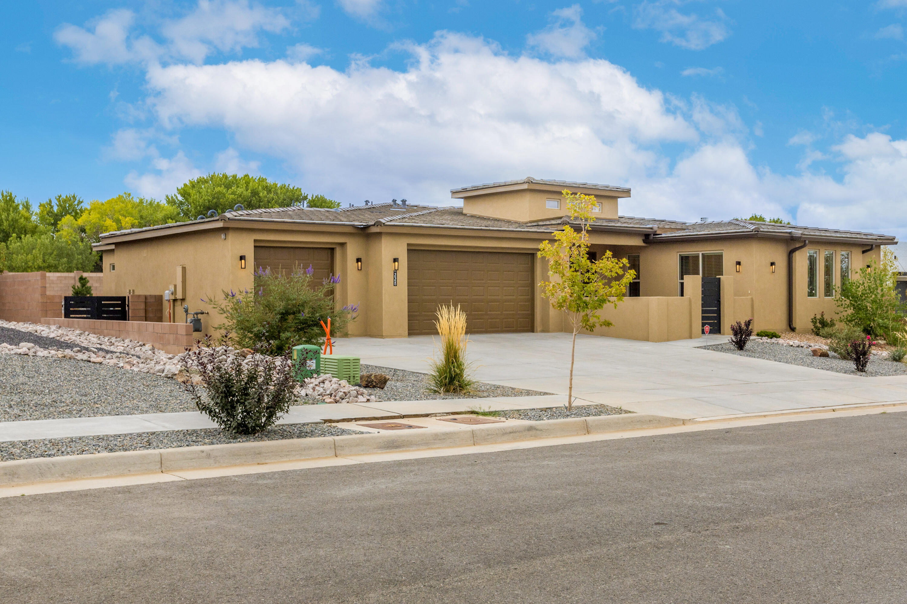 This beautiful almost new home sits on a spacious stunning, very private 1/3 acre lot in a small gated community in the North Valley conveniently located off Edith Rd between Osuna and El Pueblo. The floorplan is perfection with 4 spacious bedrooms and a very large flex space which makes an ideal office, second family room, workout room or playroom. The large three car garage has a finished floor and is sheet rocked and painted. The third garage is extra long and has a garage door on the other end that opens to the backyard. Drive your trailer, boat, etc right through. Garage door openers. Tiled roof, fully landscaped back and front yard and very large covered back patio with fans and lighting.
