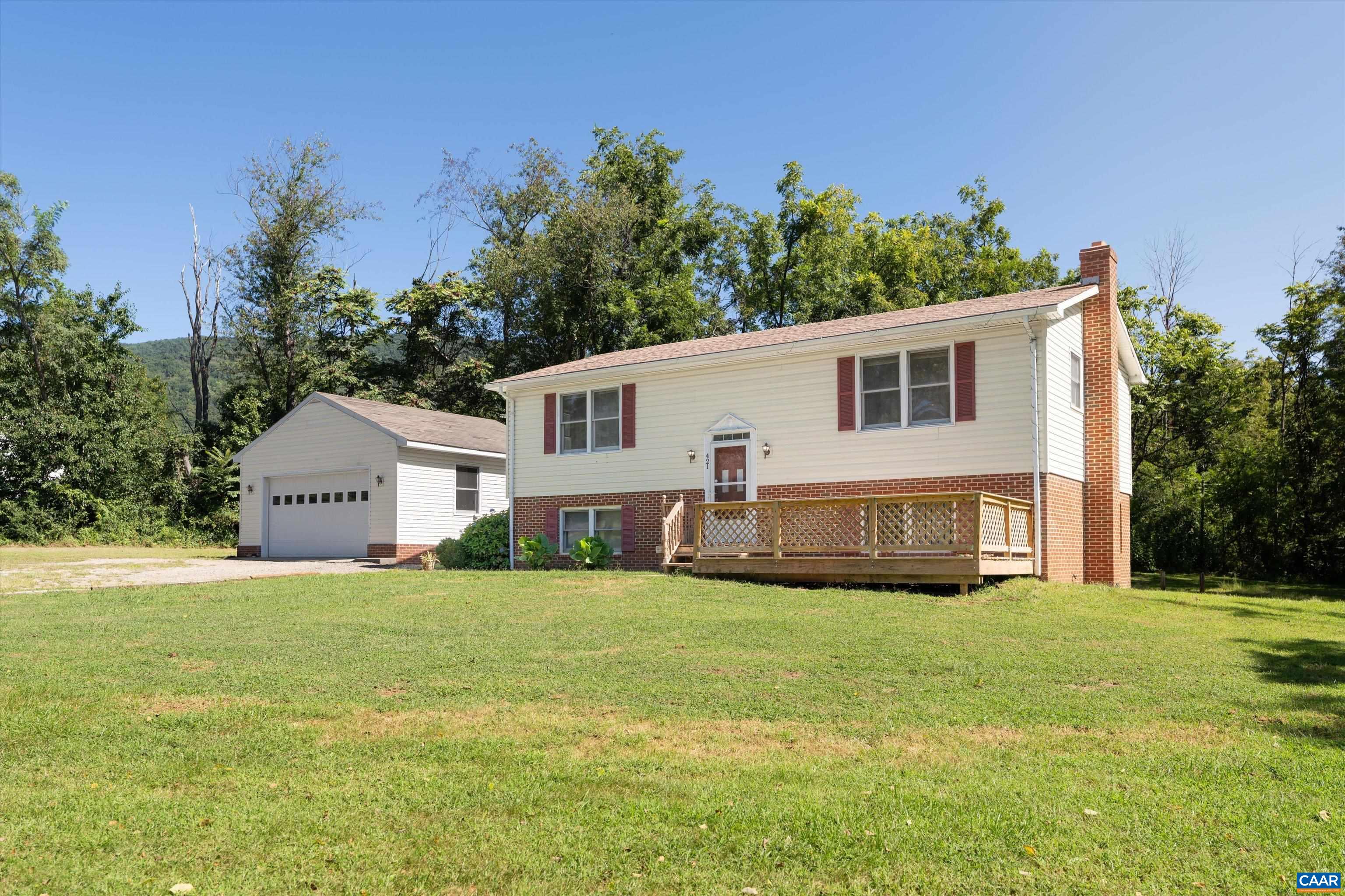 Welcome Home to 421 Newtown Road!  Located in quiet Greenwood, in Western Albemarle County, this outstanding property on 2+ perfect acres, has everything you need to feel cozy and comfortable.  The property boasts 3 spacious bedrooms, and 2 full baths.  The downstairs recreation room has limitless potential, whether you want a wide open family room, a game day retreat, a home gym, or a crafting haven, you decide!  There is also a bonus den that would serve as the perfect private office space.  The decks on the front and back of the house are the perfect places to enjoy some outdoor grilling, morning coffee, or just great spots to wind down in the evening.  The oversized detached garage is a dream for anyone who enjoys DIY projects, or working on your newest car project.  Just a short walk to Pollak Vineyards across the street, and surrounded by gorgeous mountain backdrops,  421 Newtown Road is waiting to be discovered!