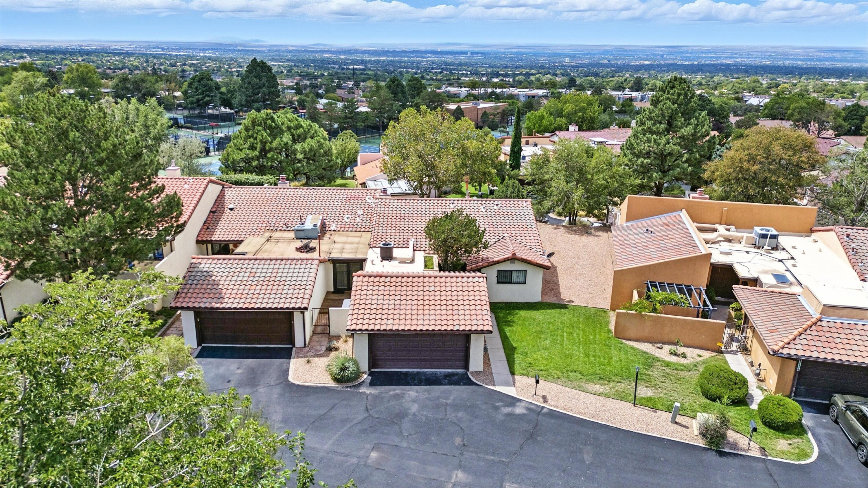 Open house Saturday, September 6 from 1:00 - 3:00. Welcome to 4413 Roxbury! Nestled in Shadow Hills, just east of Tramway off Montgomery, this charming townhome offers convenience near tennis, shopping, and dining--plus the occasional deer sighting. Recent 2025 updates include a fully remodeled kitchen, new appliances, flooring, and two stylish walk-in showers. Beautiful brick floors and a bright, open layout add warmth, while the walk-through laundry makes life easy. Sliding doors were replaced in 2017. The primary suite has a private atrium area. Detached garage is only steps away, and the HOA covers front landscaping, streets, water, sewer, and trash. Call your Realtor and schedule your showing today!
