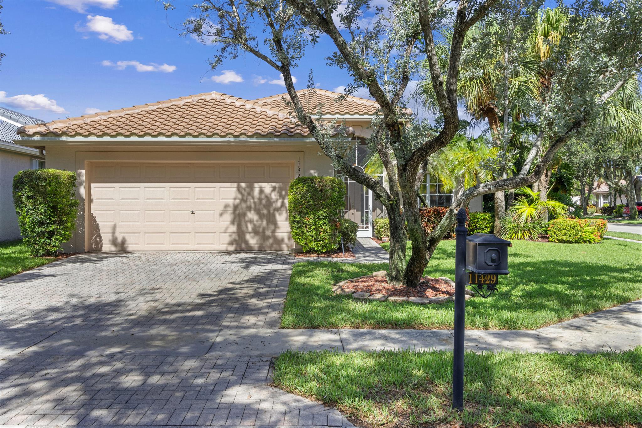 NEW ROOF! 2023! This well loved immaculate Atlantic Model is known & loved for its open concept. PRICED TO SELL, this two bedroom/two bath plus a den/office/3rd bedroom is the perfect home for entertaining or simply enjoying South Florida. Kitchen features granite countertop & backsplash, pantry & newer refrig. The 2nd Bedroom w/ deep walk-in closet. Ceramic Tile throughout the main living area with laminate in the primary and office. 2023 A/C!  Hot water heater has been replaced & new garage motor installed. Plush landscaping creates a private oasis & has partial water view. Screened lanai. 2 Car Garage. Valencia Isles renovated clubhouse features a Bistro and amenities to keep you busy all week long.  Four additional pickleball courts and 2 bocce courts coming soon!