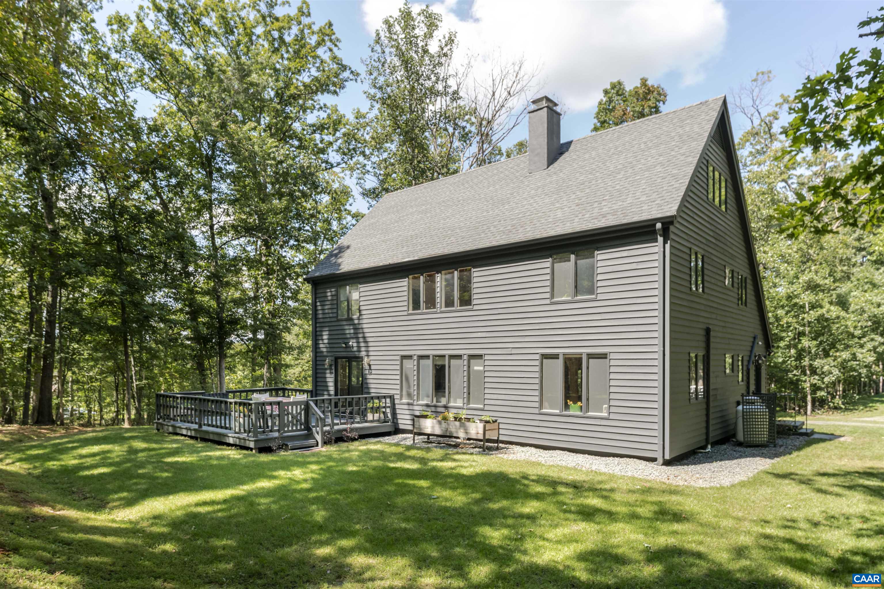 Motivated Seller! Whether making the 20-minute drive from downtown Charlottesville/UVA or the 10-minute jaunt to NGIC & the new AstroZeneca project, you will naturally unwind in the peaceful countryside of Albemarle as you arrive at 5875 Burnett Lane. Step inside this wonderfully modern take on a classic Virginia home in the serenely pastoral setting of Advance Mills. This custom-built cedar plank home has recently been updated throughout, including both downstairs and upstairs bathrooms, and a new mudroom overhaul with beautifully tiled floors. The interior and exterior have both been painted within the last year and the home blends seamlessly into the wooded landscape. The addition of under-cabinet lighting in the kitchen highlights the brand-new Samsung convection oven, LG cooktop, and Bosch dishwasher. Heated kitchen floors and covered gutters keep the country comfortably outside the new custom Anderson sliding glass doors. The lot was recently graded and landscaped with the addition of a mile-long private network of trails. Brand new tankless water heater, and well pump. Custom shelves and lighting compliment a new closet in the primary room. Should the need arise, rest assured with a generator ready to provide backup power.