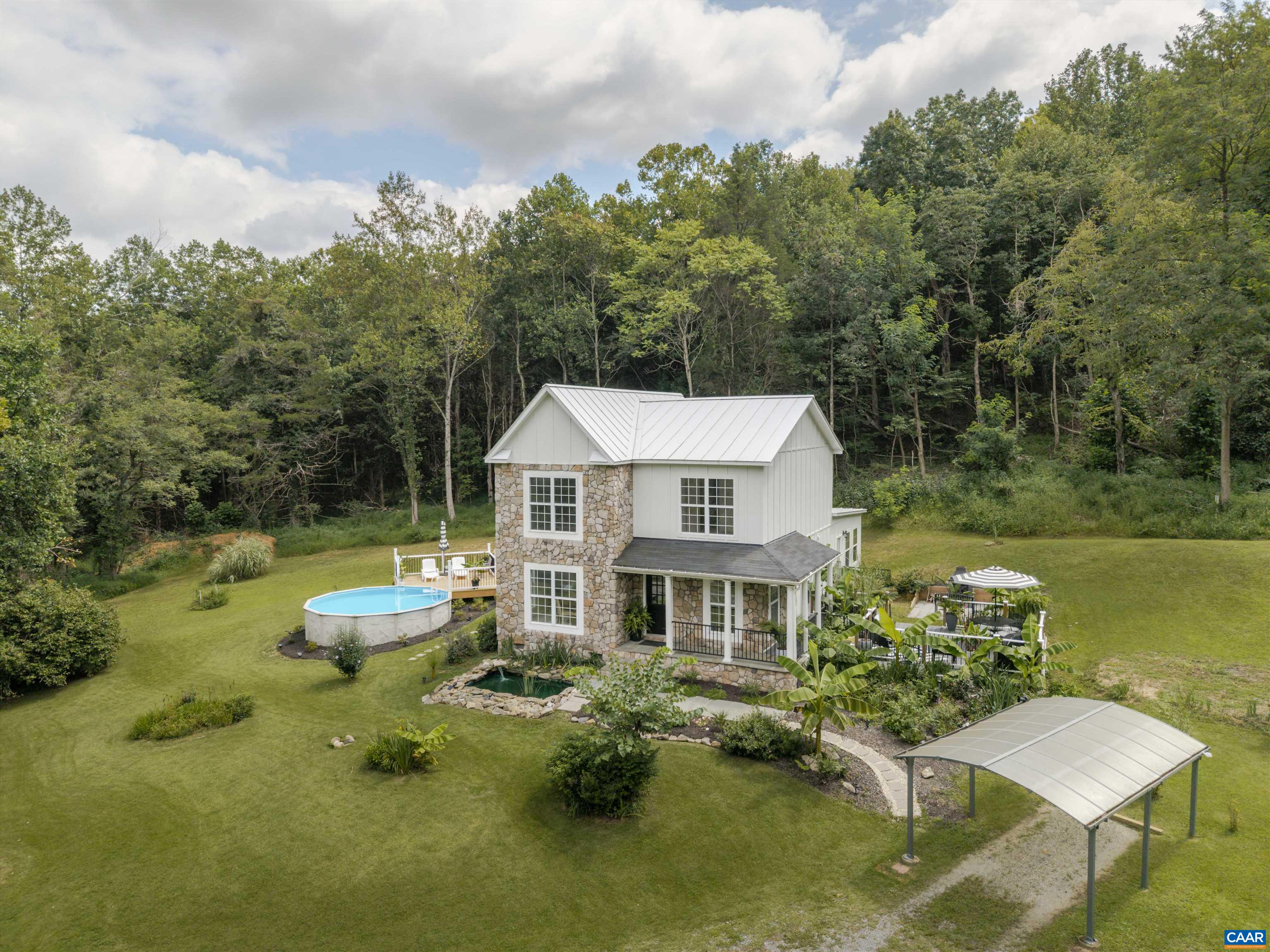 Private Sanctuary on 15+ Acres in Western Albemarle, offered for the first time. This meticulously maintained home is set on over 15 acres under conservation easement, with neighboring properties also protected, ensuring complete privacy and no future development. Located just 5 minutes from downtown Crozet and 20 minutes to Charlottesville, it offers the perfect blend of seclusion and convenience. Enjoy mountain views and a beautifully landscaped setting designed to be your personal oasis. The home features over $266,000 in upgrades, including a new addition, low-maintenance metal roof, new carpet and LVP flooring, and a private pool with new decking. The exterior boasts durable HardiePlank board and batten siding with stone veneer accents. Inside you’ll find two upgraded walk-in showers and custom built-in cabinetry in the primary suite.  Every detail has been thoughtfully updated to enhance both comfort and style. Don't miss your opportunity to own a unique, private, protected retreat in sought-after Western Albemarle.
