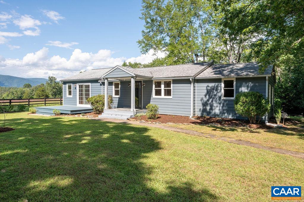 This quintessential Western Albemarle farmette boasts magical Blue Ridge views (which are protected by surrounding conservation easements), several acres of flat, sunny pasture ringed by shady woods for complete privacy, raised garden beds, extensive plantings, fruit trees, a majestic oak, a chicken coop and run (protected by electric fence), a garage/outbuilding with many possible uses! Enjoy one level living in the cottage style home, packed with updates & upgrades including a new kitchen, fabulous stone-floored living room w/woodstove, a reconfigured primary suite w/tiled shower and much more. This home has abundant character and charm, flexible spaces to suit your needs, an electric dog fence, gutter guards, tankless water heater & whole house generator for easy living, and potential expansion/project space in the cellar. Wake to deer, wild turkey and other wildlife. Bring your horses, other furry friends & your green thumb! The mountain views are ever-changing & the star-filled sky is simply spectacular on the dark country nights. Please see docs for floor plans and list of extensive recent updates. Firefly broadband installed. Western Albemarle Schools.