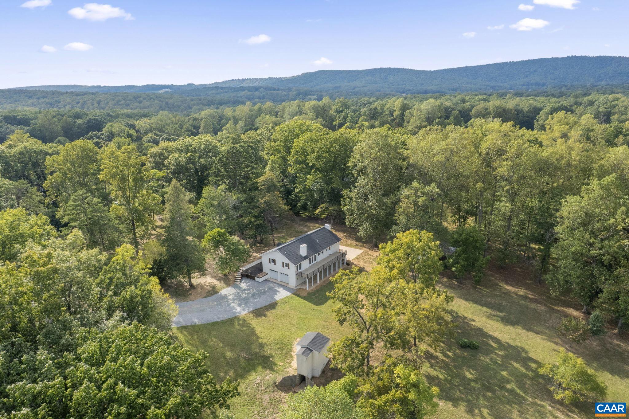Completely renovated all-brick home in Southern Albemarle County on almost 7 acres.  This home is only 15 minutes from Charlottesville.  The split-level home has 5 bedrooms and 3 full baths.  Upstairs, there is a gorgeous kitchen with custom cabinets, granite countertops, an island with seating, a pantry with pull-out shelving, a wine fridge, and a beverage area. Dining area that looks into the kitchen and family room with a masonry wood-burning fireplace.  On this level, you will find the master suite with 2 closets (1 walk-in), double vanities, and a 5'x6' tile shower, plus 2 additional bedrooms and a full bathroom.  On the lower level, there are 2 bedrooms, 1 full bath, a family room, and a laundry room. 2-car garage in the basement.  On the rear of the home, there is a deck the length of the home with a patio below, plus a side patio.  3 outbuildings - one would be perfect as a small barn for farm animals.  The owner is a licensed realtor in Virginia.