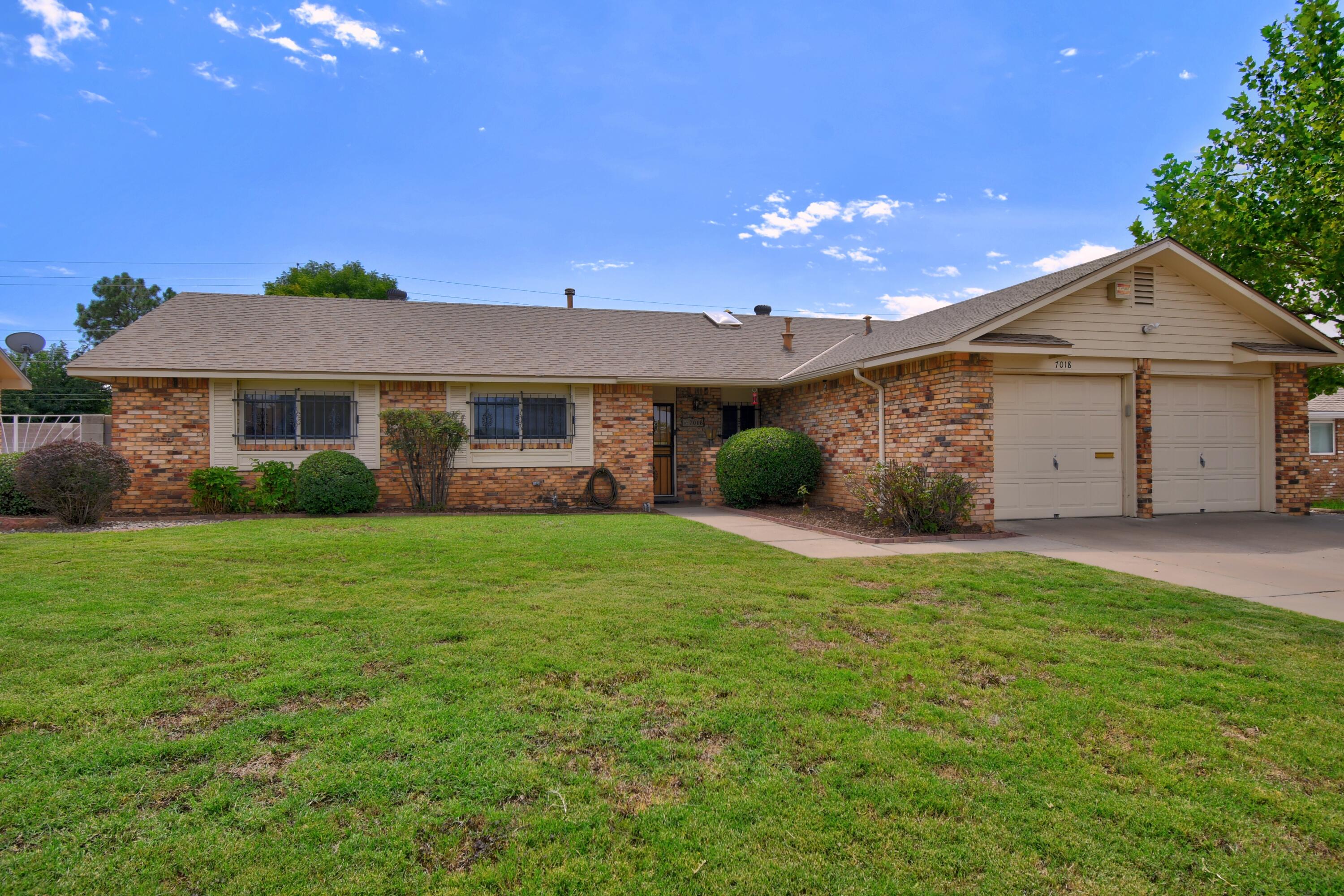 Beautifully refreshed single-story in the desirable Sandia High School district! This home has a bright and open floor plan with refrigerated air! Recently updated with new carpet & fresh paint. Spacious kitchen now overlooking the dining area! 2 living areas, ceiling fans, vinyl double paned windows, recessed lighting & wood burning fireplace!  Huge mature and private backyard!