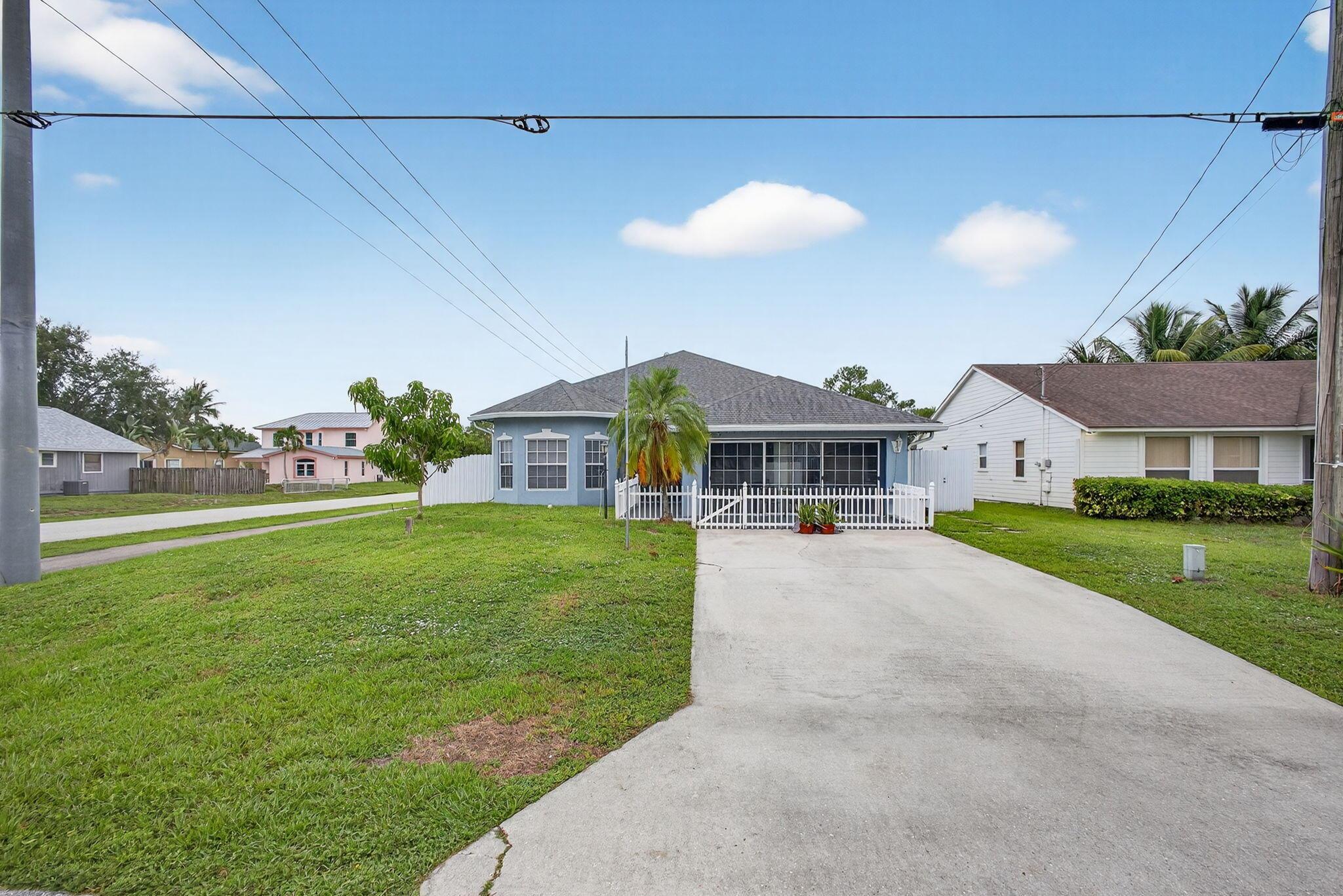 Beautifully maintained 4 bedroom, 2 bath home in the desireable Jupiter Heigths neighborhood. Builder's model home, only one in the neighborhood. Open floor plan from front to back with soaring cathedral ceilings. Desirable fenced corner lot with both tiled front patio, and screened back patio, home office, eat-in kitchen with solid  ceramic tile and wood laminate floors in all living areas. French doors lead to patio. Master features tray ceiling, walk-in closet, spa tub, separate shower and dual sinks. New roof installed 2020.
