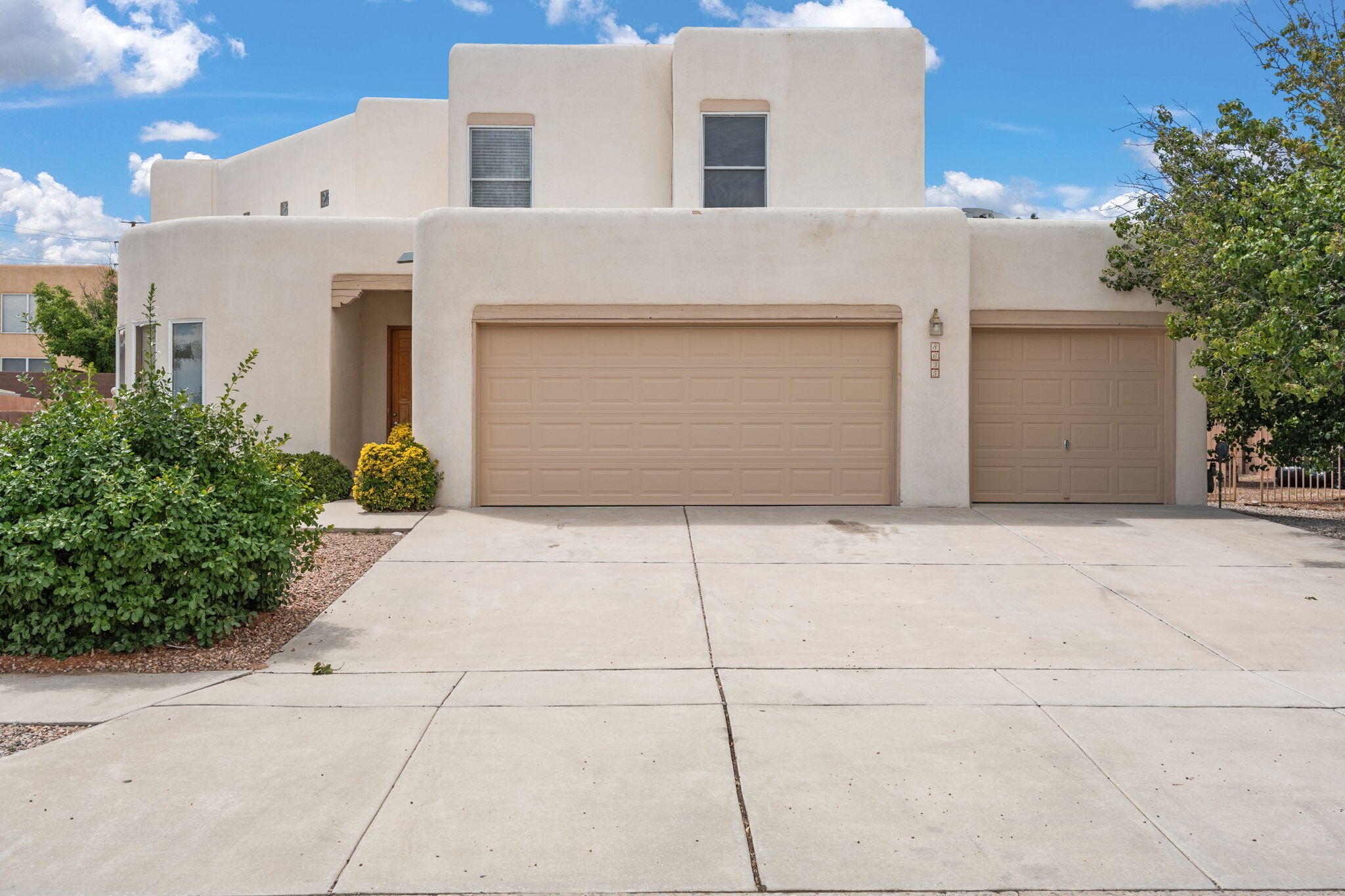 This outstanding former Tiffany model home sits on a massive corner lot with a 3-car garage and gated side yard access--perfect for your boat or RV! Recent upgrades include a new roof, updated refrigerated air unit, and new flooring upstairs. The Pueblo-style design features soaring beamed ceilings, a stunning stacked stone fireplace, and walls of windows for abundant natural light. The open kitchen/dining area is equipped with granite counters, a breakfast bar, warming drawer, pantry, and wine cooler, with direct access to the backyard. A private Owner's suite offers balcony access with views over the walled yard. Easy-care xeriscape landscaping completes this move-in-ready gem.