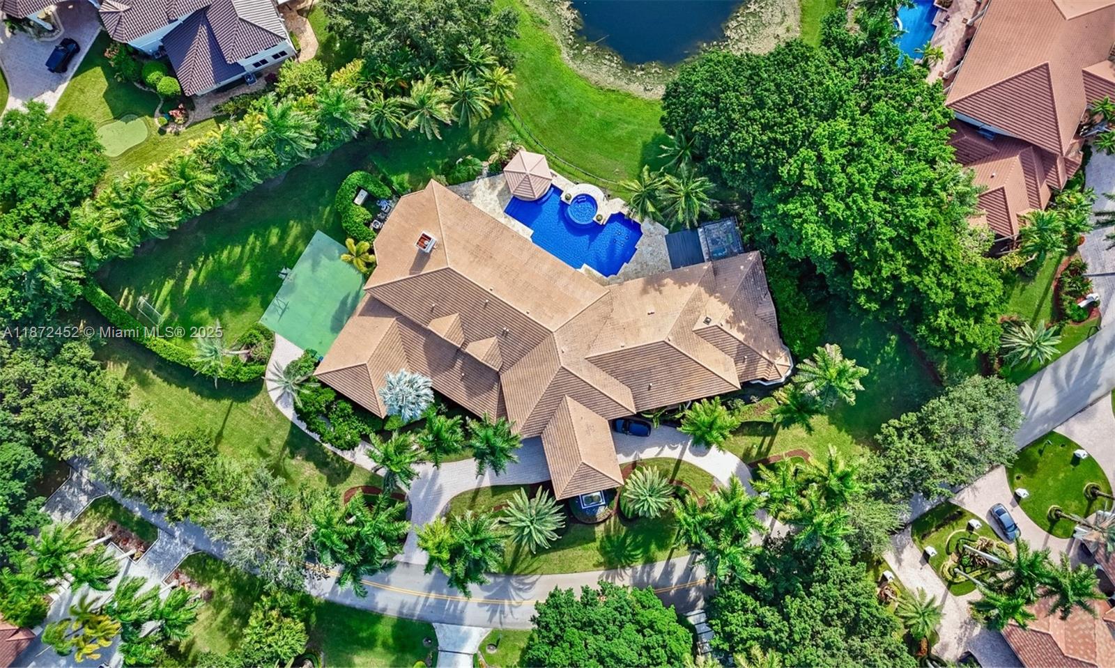 Experience refined lakefront luxury in the prestigious gated community of Windmill Ranch Estates. This meticulously updated estate spans 7,647 SF (10,587 adj. SF) on a 1.5-acre lot, showcasing breathtaking water views and unparalleled privacy. This extraordinary estate features 6 BD, 8.5 BA, office, custom home theater, & billiard room with bar. Soaring 20-ft ceilings and expansive windows fill the open layout with natural light. The gourmet kitchen is equipped with top-tier appliances, 3 Infinity Pro Wine Cooler, and a double-sided fireplace. Outside, enjoy your private resort-style oasis with a lake view pool with new water fixtures, swim-up bar, sunken gazebo, and a fully equipped summer kitchen, all overlooking serene lake views. Additional upgrades include 2021 roof, 4 new A/C units