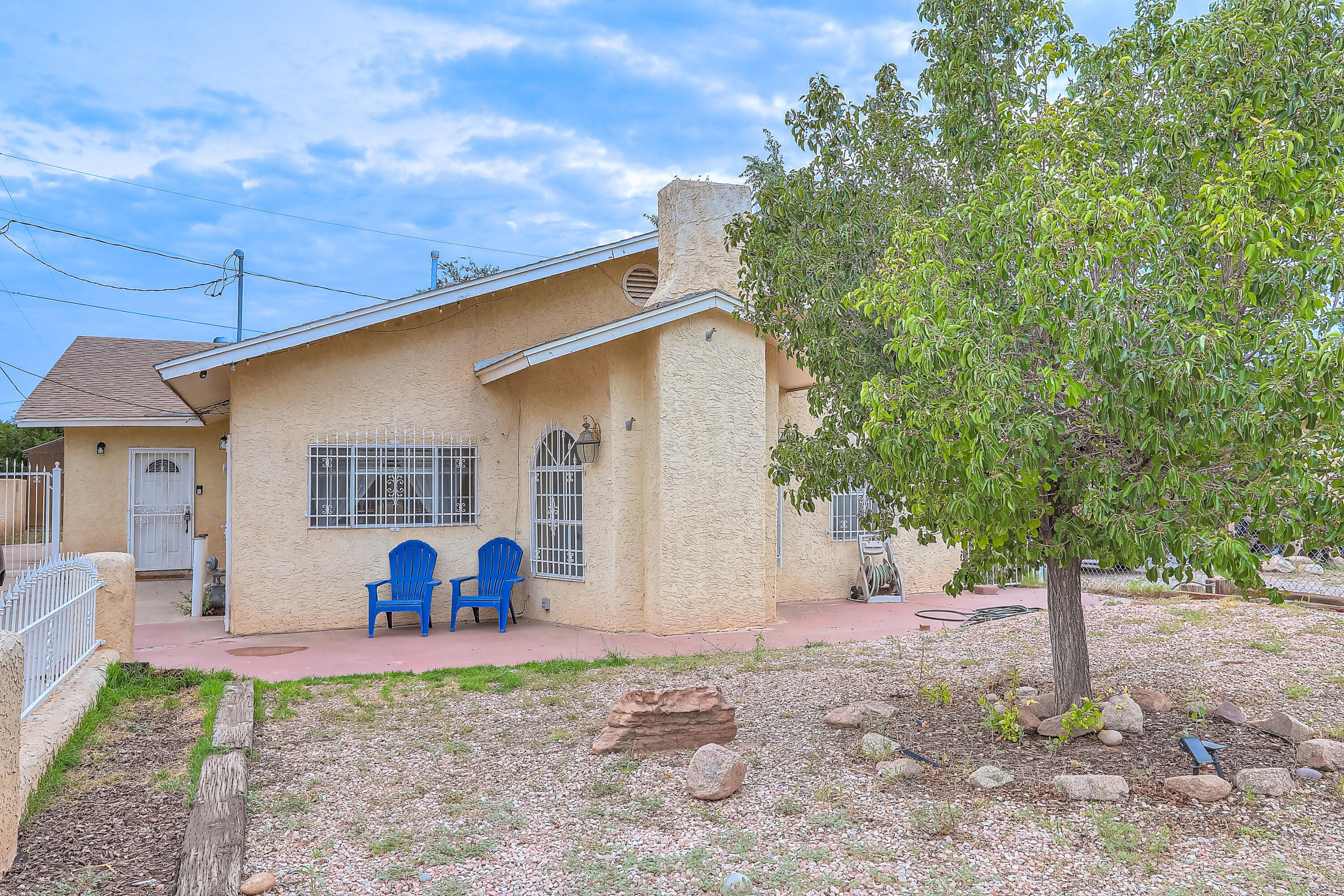 Get ready to fall in love with this North Valley gem, perfectly situated near restaurants and shopping with easy access to I-25! This beautiful home offers the ideal blend of comfort, convenience and character. As soon as you step inside, you'll discover the heart of the home - a versatile living space that can host lively game nights, movie marathons or quiet evenings curled up with a book.  The primary bedroom is a huge dreamy retreat with an oversized walk-in closet for all of clothes and accessories. Two additional bedrooms sharing a large bathroom with a cozy fireplace the perfect set up for family, guests or even a home office. The backyard features a fire pit and endless possibilities - whether you want a garden, play area or a relaxing hammock to watch the vibrant NM sunsets.