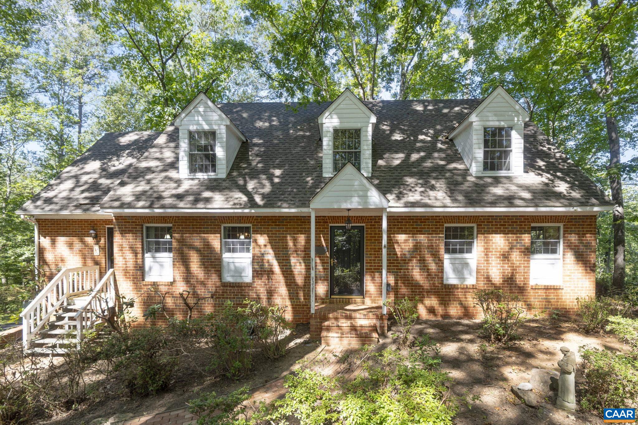 A classic Colonial Cape Cod perched on a knoll overlooking an expansive field with long frontage on Stockton Creek in Western Albemarle. This fine county property offers complete privacy with Blue Ridge mountain views and wonderful convenience to western Albemarle schools and Crozet. A custom brick home offers an open floor plan with many traditional features; such as heart pine flooring & wood-burning fireplace & wood stove. The rear elevation has a screened porch that is flanked by decking on both sides. Full walk-out basement with home office and two-car garage. Central vacuum, home generator and second floor storage room. Land is suitable for horses, other livestock or crops with a small two-bay barn. Great garden space. 2,265 feet of frontage on the Stockton Creek makes this a great recreational property that attracts all types of wildlife. Development rights.