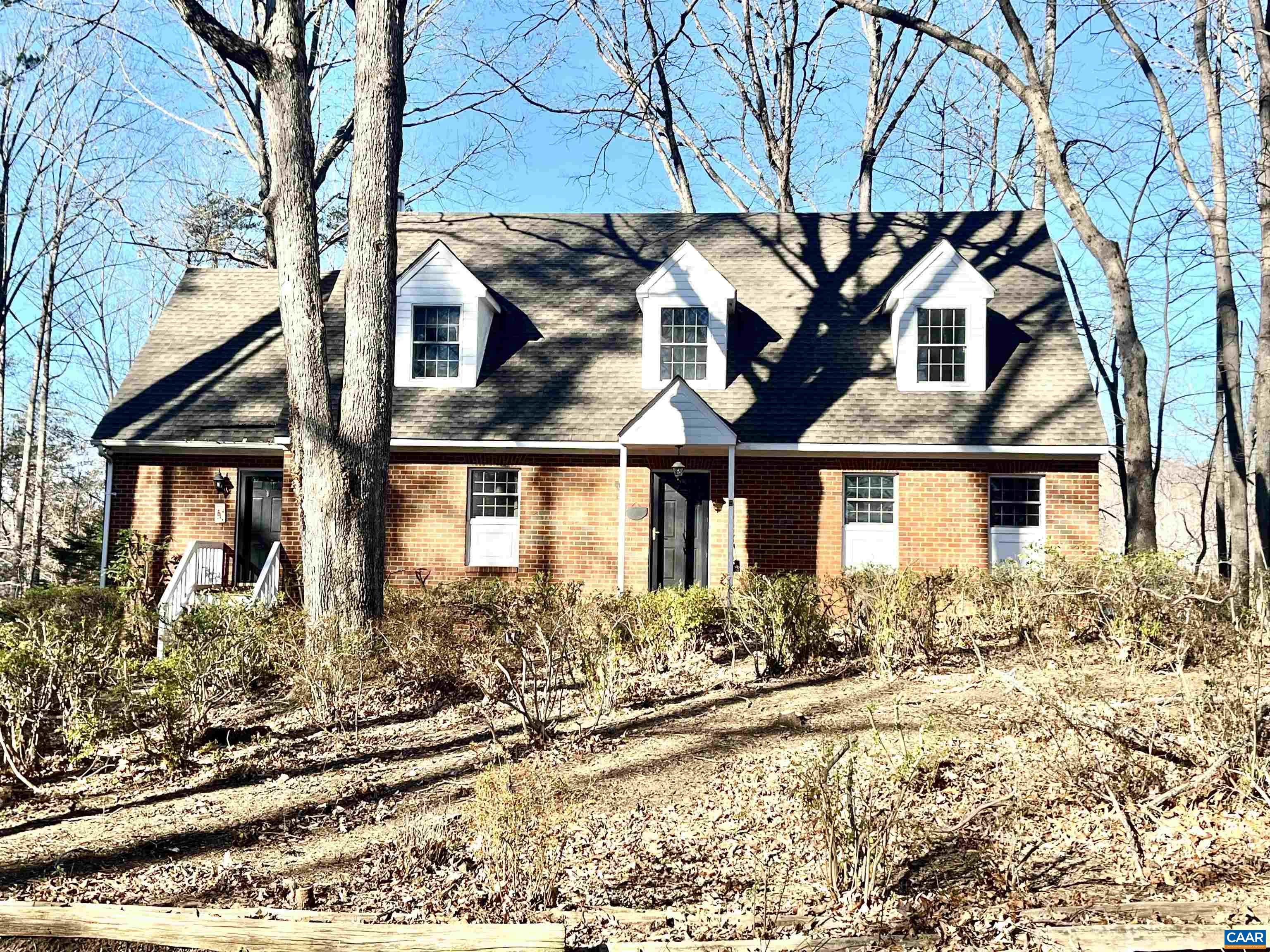 A classic Colonial Cape Cod perched on a knoll overlooking an expansive field with long frontage on Stockton Creek in Western Albemarle. This fine county property offers complete privacy with Blue Ridge mountain views and wonderful convenience to western Albemarle schools and Crozet. A custom brick home offers an open floor plan with many traditional features; such as heart pine flooring & wood-burning fireplace & wood stove. The rear elevation has a screened porch that is flanked by decking on both sides. Full walk-out basement with home office and two-car garage. Central vacuum, home generator and second floor storage room. Land is suitable for horses, other livestock or crops with a small two-bay barn. Great garden space. 2,265 feet of frontage on the Stockton Creek makes this a great recreational property that attracts all types of wildlife. Development rights.