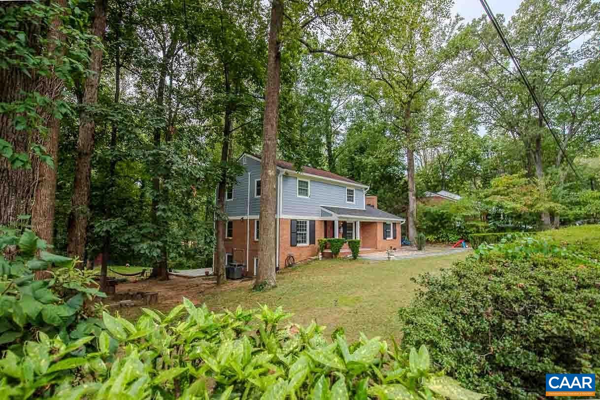 Nestled on a peaceful, tree-lined lot in Barterbrook, this updated 3 bedroom, 3 full bath Colonial offers the perfect mix of charm, space, and modern upgrades—all just minutes from the Shops at Stonefield, Barracks Road, UVA, and more. Inside, you'll find a freshly painted interior (2025), hardwood floors throughout the main living area, and brand new LVP flooring in the kitchen and family room (2025). The layout features a spacious living room with a fireplace, formal dining area, and a cozy family room with a second fireplace. The massive, just-renovated kitchen showcases granite countertops, tile backsplash, stainless steel appliances, and ample storage and prep space. The primary suite offers dual closets and an attached full bath, while the walk-out basement provides a finished den, workshop, and abundant storage. Outdoor spaces are ideal for entertaining, with a large back deck, stone patio, and covered front porch. Additional highlights include a partial new roof, one recent HVAC system (with another in process), updated exterior doors and windows (2013), and a storage shed. The backyard is a private oasis with a natural, open feel—perfect for gatherings or peaceful relaxation.