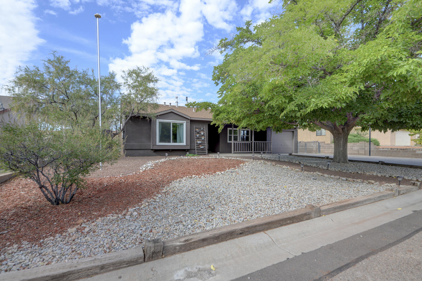 Impeccably maintained home in heart of River's Edge offers so many improvements...where to start? Renovated kitchen and new appliances (2025). Newer Champion Low-E windows (2025) and two skylights bring in natural light, high ceiling in living room. Solar panels are owned, resulting in monthly electric bills under $20. Refrigerated air (2018), Rinnai tankless water heater (2018). Spacious primary bedroom, comfortable floorplan.  Flooring all tile and elegant laminate (no carpet). Backyard offers views of the Sandia Mountains, a sophisticated gazebo area for outdoor entertaining, along with a firepit for the cozy autumn evenings. Two parks close by. A pleasure to see!