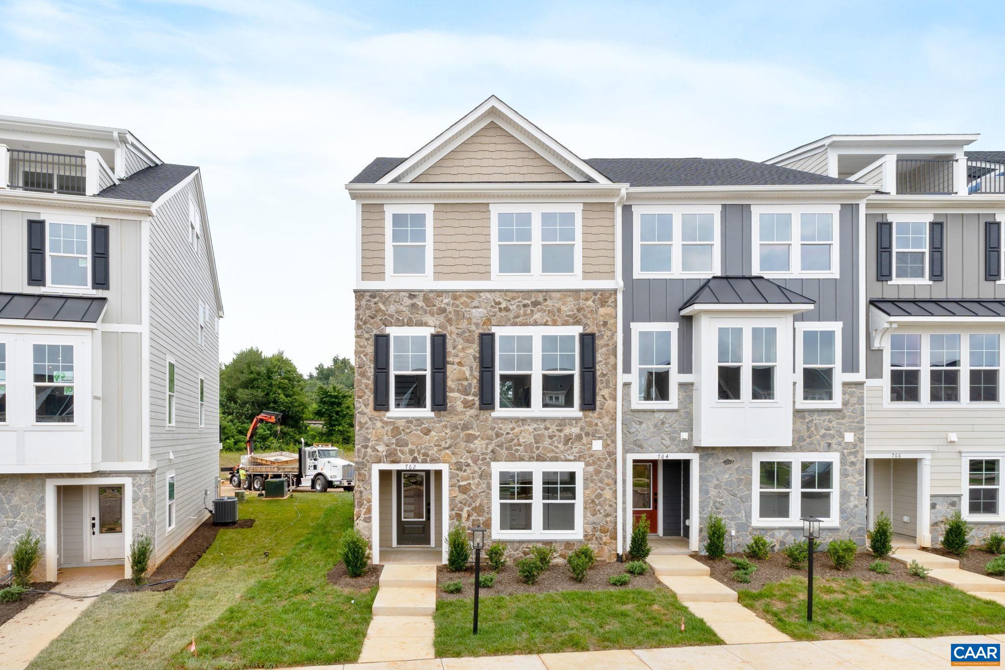 Just completed - actual photos! This end unit Poplar II townhome in Glenbrook offers a comfortable, farmhouse-style layout surrounded by mountain views, green spaces, and walking trails—all within easy reach of downtown Crozet. This interior unit features a bright kitchen with plenty of prep room and a walk-in pantry, a spacious rear deck off the main level, and a first-floor bedroom with its own full bath that works well for guests or a home office. You'll find thoughtful touches throughout, like oak stairs, solid core interior doors, wood shelving, and an energy-efficient furnace. A two-car garage is included for added convenience. Community perks include a nearby path to Crozet Park and future access to downtown via a planned trail.