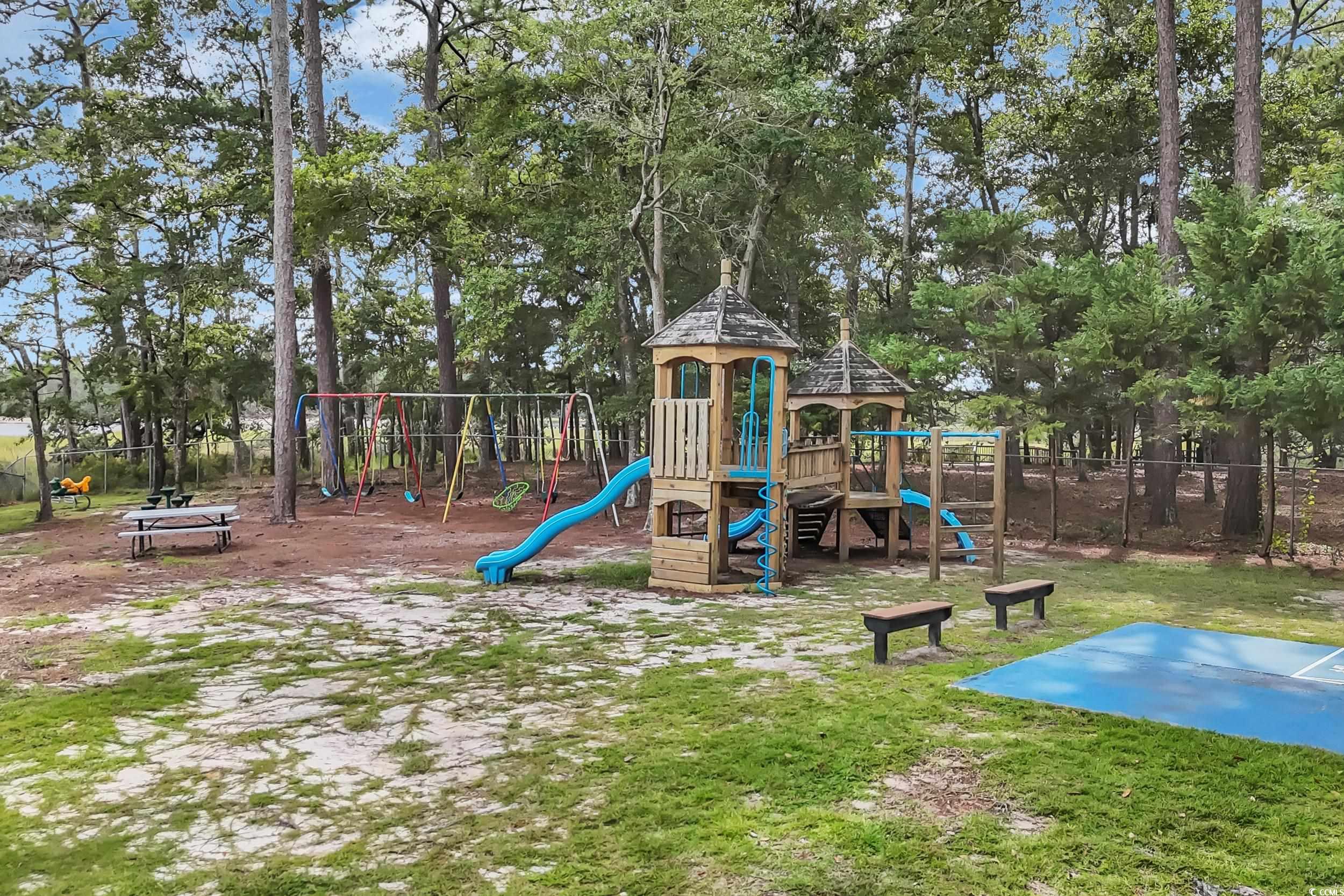 Community play area with view of wooded area