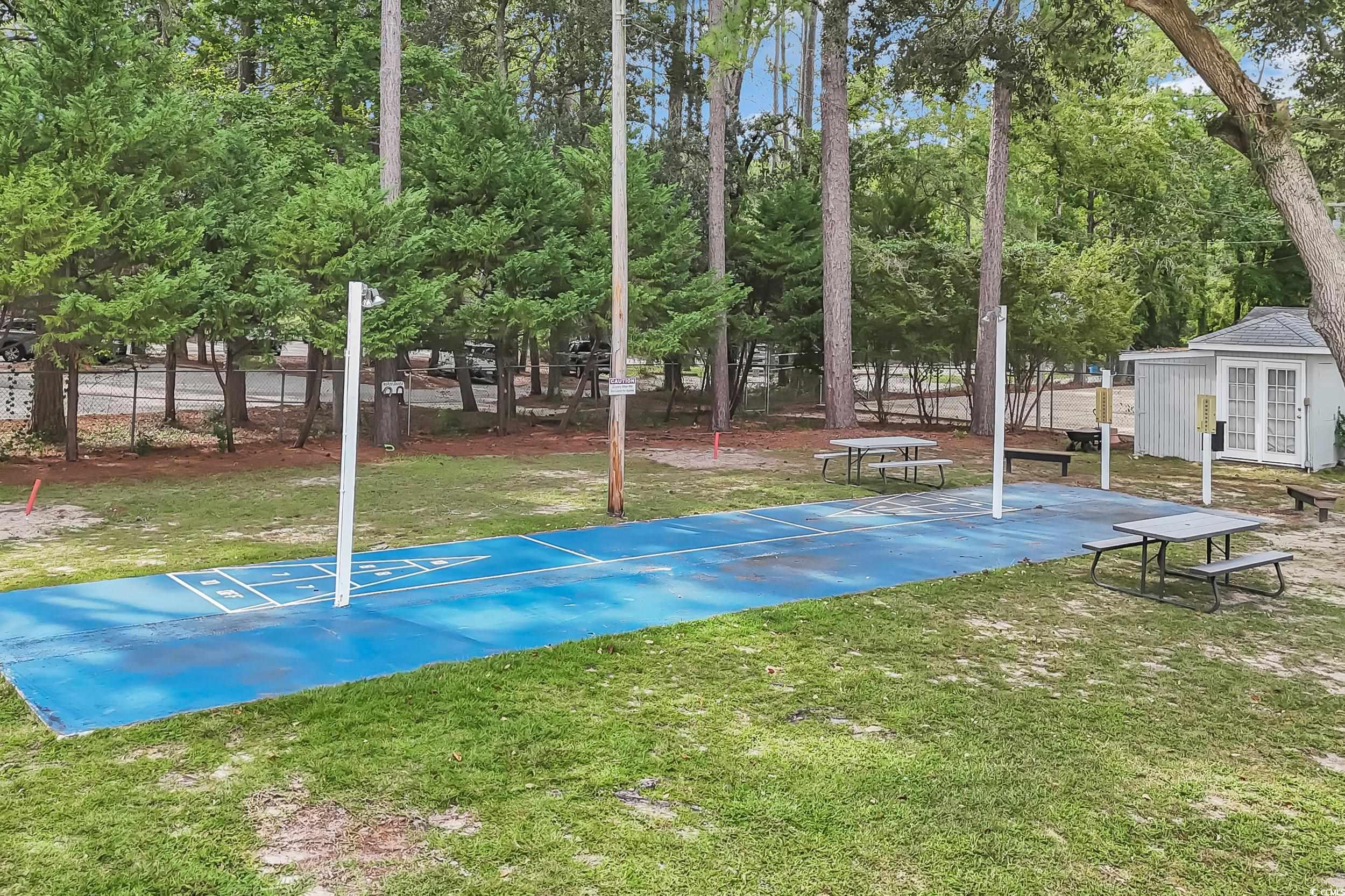 View of home's community with shuffleboard