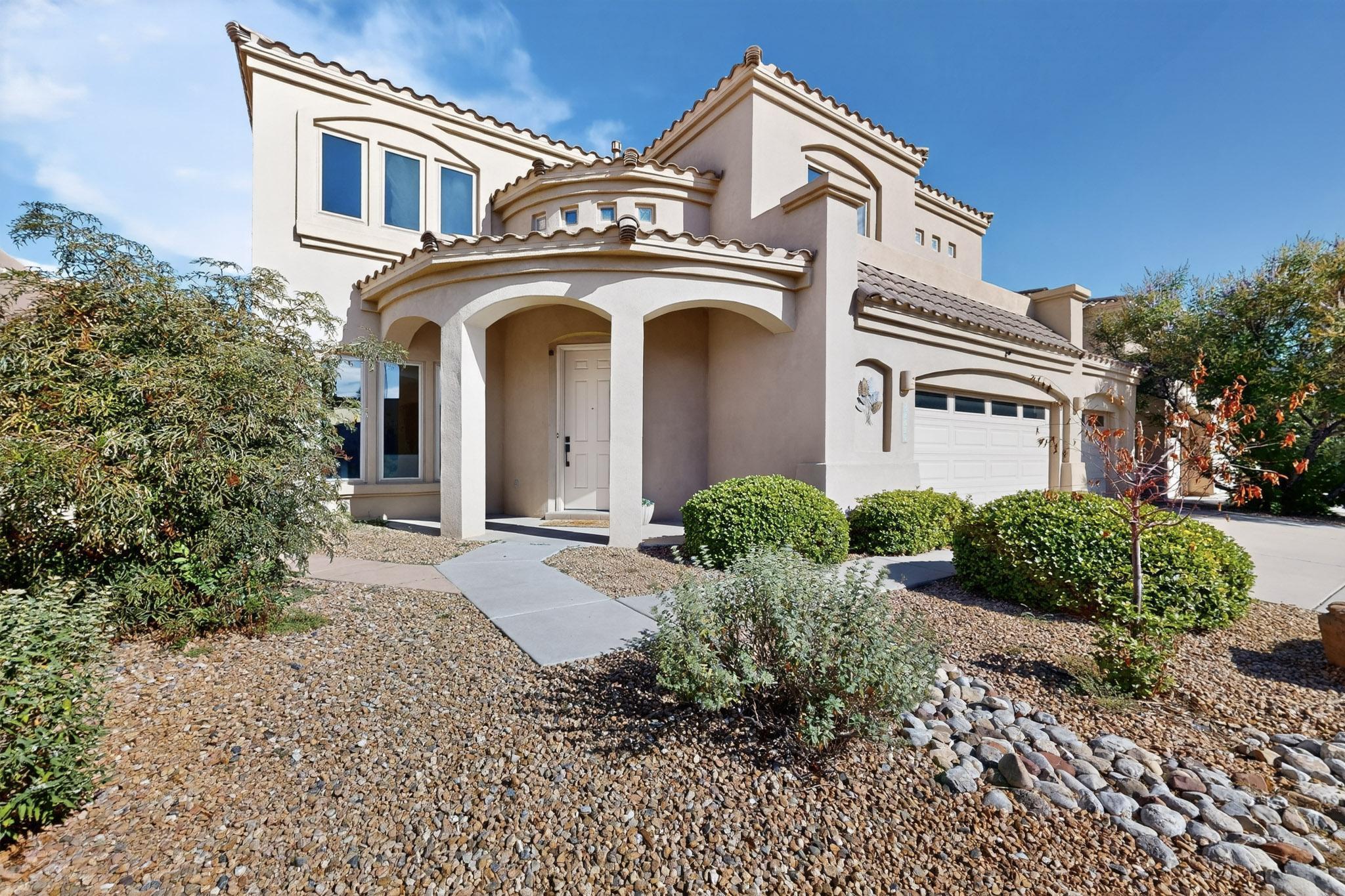 A beautiful home located in the prestigious Oxbow North gated community, this home offers a downstairs bedroom with full bath and four spacious bedrooms on the second level.  There is plenty of room for everyone with 2 living spaces and a cozy fireplace in the family room with open floor plan. Large kitchen for every occasion. Easy maintenance front and backyards. Large primary bedroom with balcony and views of the Sandia Mountains.Oversized 3 car garage and new carpet and paint throughout the home. Close to dining and shopping.