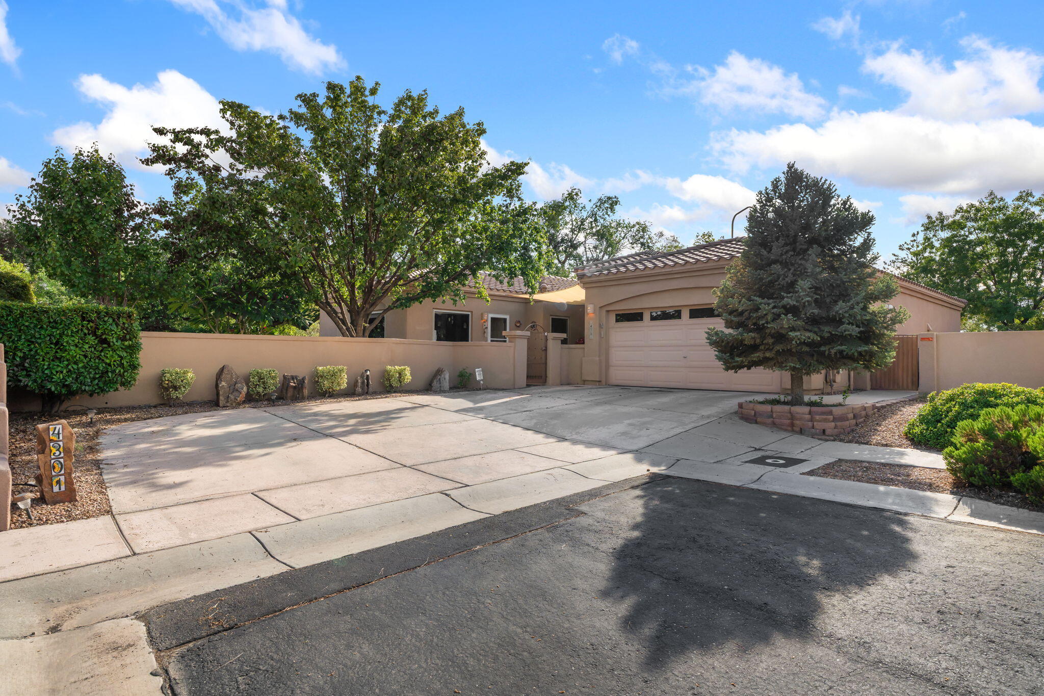 Gorgeous home on a spacious corner lot in the desirable gated community of Oxbox North! The enclosed front courtyard welcomes you with mature trees, bushes, and a peaceful water feature. The backyard offers another water feature, lawn, covered patio, and lush landscaping, creating a private oasis. Inside, you'll find 3 bedrooms plus a flexible 4th bedroom/office conveniently located off the courtyard. The elegant living room features a gas log fireplace, while the primary suite boasts dual walk-in closets. Enjoy year-round comfort with refrigerated air conditioning. This home blends privacy, beauty, and functionality in a sought-after neighborhood.