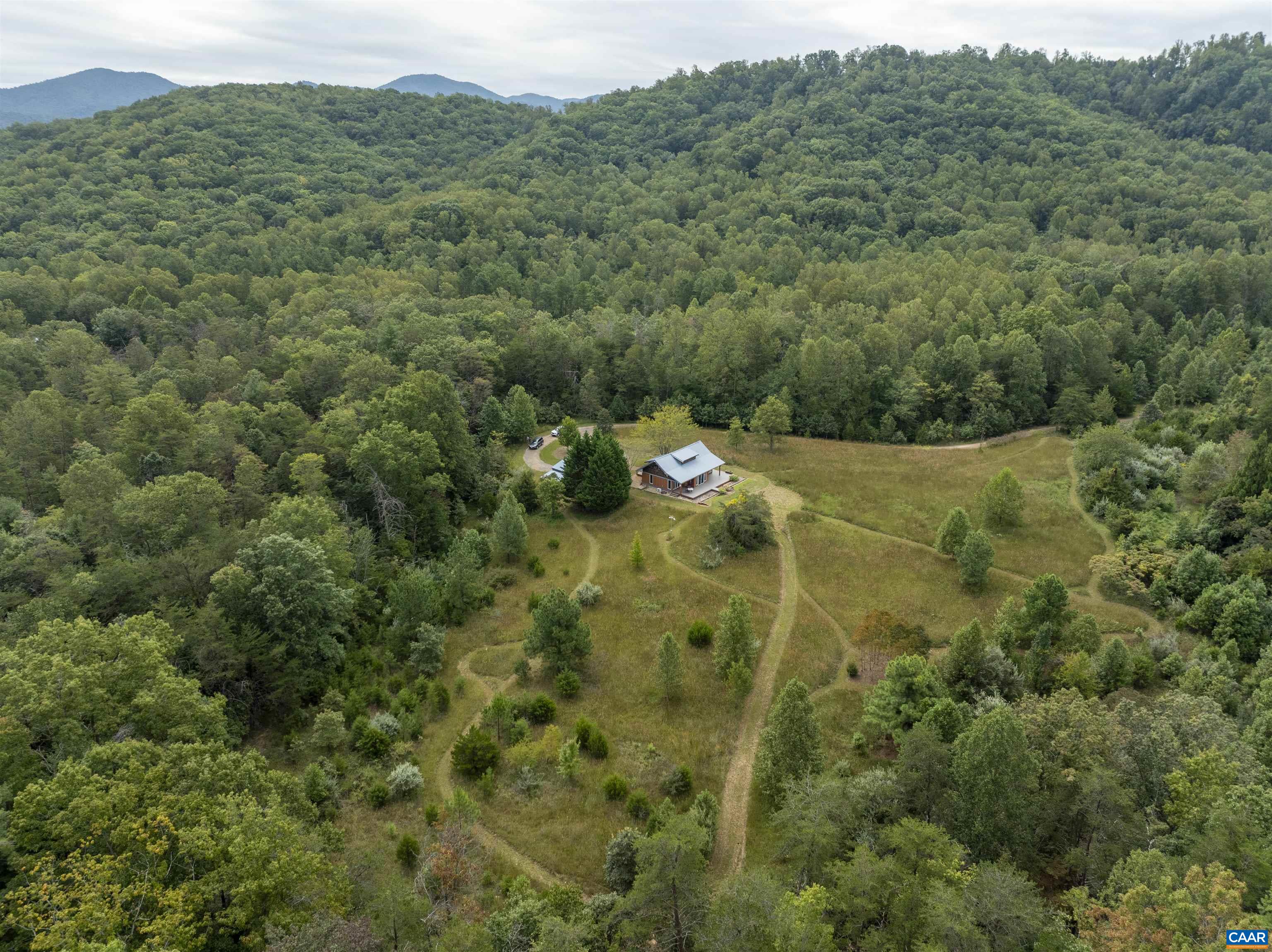 Enjoy starry nights, expansive Blue Ridge Mountain views, quiet and privacy in this craftsman style cottage on 15.57 acres in both Albemarle and Nelson Counties.  Located within minutes of the Nelson County Brew Trail and 12 minutes to the Blue Ridge Parkway and Skyline Drive. Easy shopping in Waynesboro and Crozet or 30 Minutes to C-Ville.  This is the perfect second home or possible part time Airbnb or full time residence that could be expanded on.  There are walking trails mowed into the open land that is left natural for wildlife and butterflies and usually cut in the Spring. The wooded land has a mixture of hardwoods and the fall color is spectacular, Spring brings many native flowers and hundreds of daffodils are planted in the circular drive way. Many recent improvements include mini split for HVAC, new vapor barrier and insulation in the crawl going in next week, hooks ups added for a stack washer and dryer. The storage shed has electricity and makes a perfect workshop of all your crafting ideas and extra storage. This is truly a very special home and setting and the views will only improve as the leaves fall. Come cozy up by the pellet stove and  let your spirit run free. One year Cinch home buyers warranty included.