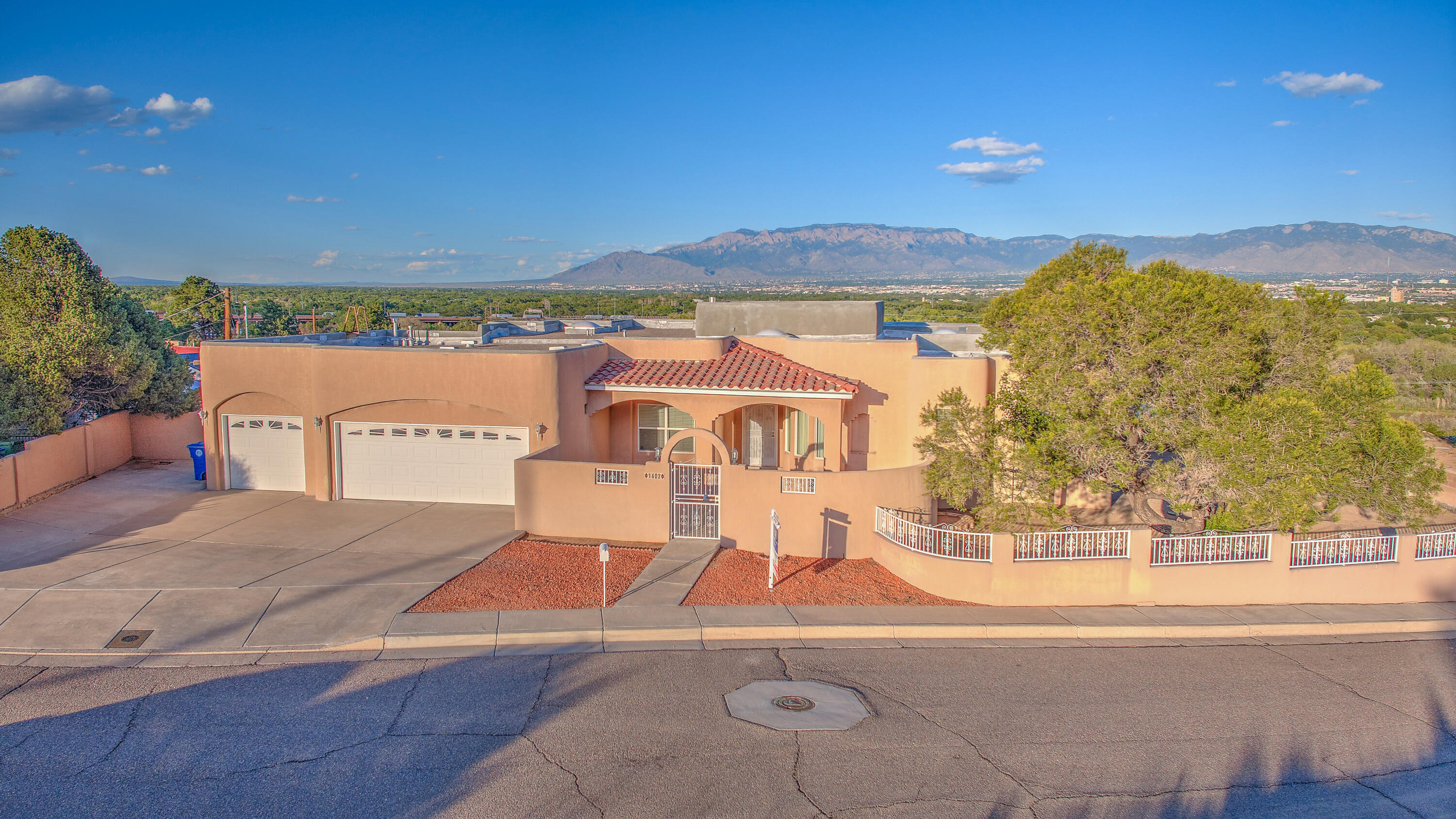 Views View Views! This Riverview Heights custom masterpiece captivates w/breathtaking panoramic views. The corner lot offers extra land for future vision, while a private courtyard creates a welcoming vibe. Brand new roof! Inside, timeless details shine-hardwood floors, SW beams, lighted nicho, kiva-style gas FP, and the perfect blend of formal dining and sunny eat-in kitchen. Skylights and abundant windows bathe each room in natural light. Each bed has its own bath, plus an add'l guest 1/2. The primary is a retreat with mesmerizing views, screened patio, spa-inspired bath w/dual vanities, jetted tub, and huge walk-in. Extras include refrigerated A/C, ceiling fans, a laundry room with washer/dryer and abundant storage. Unwind on the covered back patio as endless vistas stretch before you!