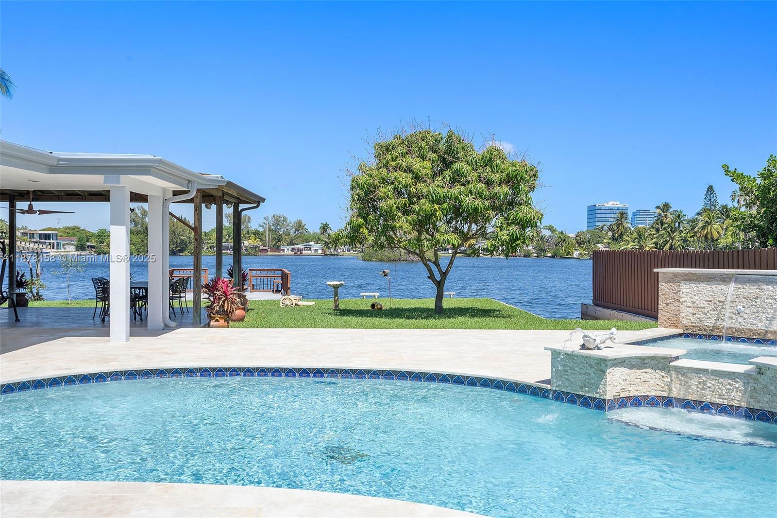 Rare Waterfront and Ocean Access in Aventura ! This fully renovated single-home masterpiece is in the prestigious Enchanted Lake neighborhood of Aventura.Ocean access and sits on a waterfront lot:75 feet. The interior boasts a high-end gourmet kitchen with custom cabinetry, high ceilings, and two master bedrooms, perfect for living and entertaining.Brand-new pool complete with a jacuzzi and waterfall. Private boat ramp with a dedicated deck and a spacious backyard ideal for hosting private events or relaxing by the water. It offers a luxurious retreat with water views from living areas,blending comfort and elegance.Prime location just minutes from Aventura Mall, top-rated schools, fine dining, parks, and major highways, as well as international airports.( allowed for Short- term rental) .