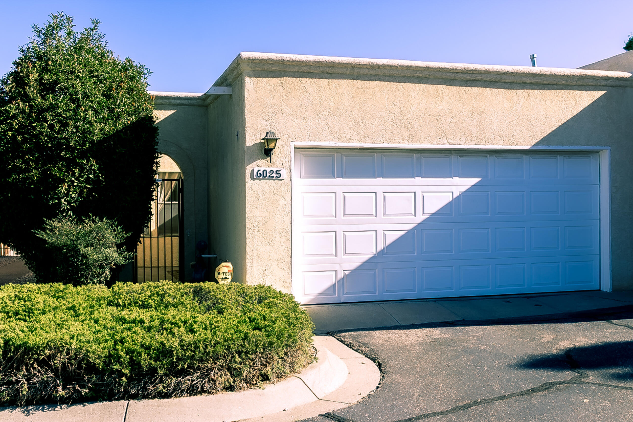 Upgraded home with open floor plan connecting kitchen, dining, and living areas & newer ref AC! Kitchen features updated ceramic tile floors, granite countertops, custom glass tile backsplash, recessed sink w/ brushed nickel fixture, maple shaker style cabinets, new stainless steel electric range, SS dishwasher, breakfast bar & pantry cabinet. Living area includes a gas log fireplace w/ custom tile surround. Owner's suite offers a full bath w/ tub/shower combo, upgraded vanity, tile flooring & ceiling fan. Additional bath has a walk-in shower w/ seating & skylight for natural light. Laundry room incls custom shelving. Finished garage w/ insulated door & electric opener. Ext highlights incl a private front courtyard & a backyard patio w/ concrete pavers & access to public areas.