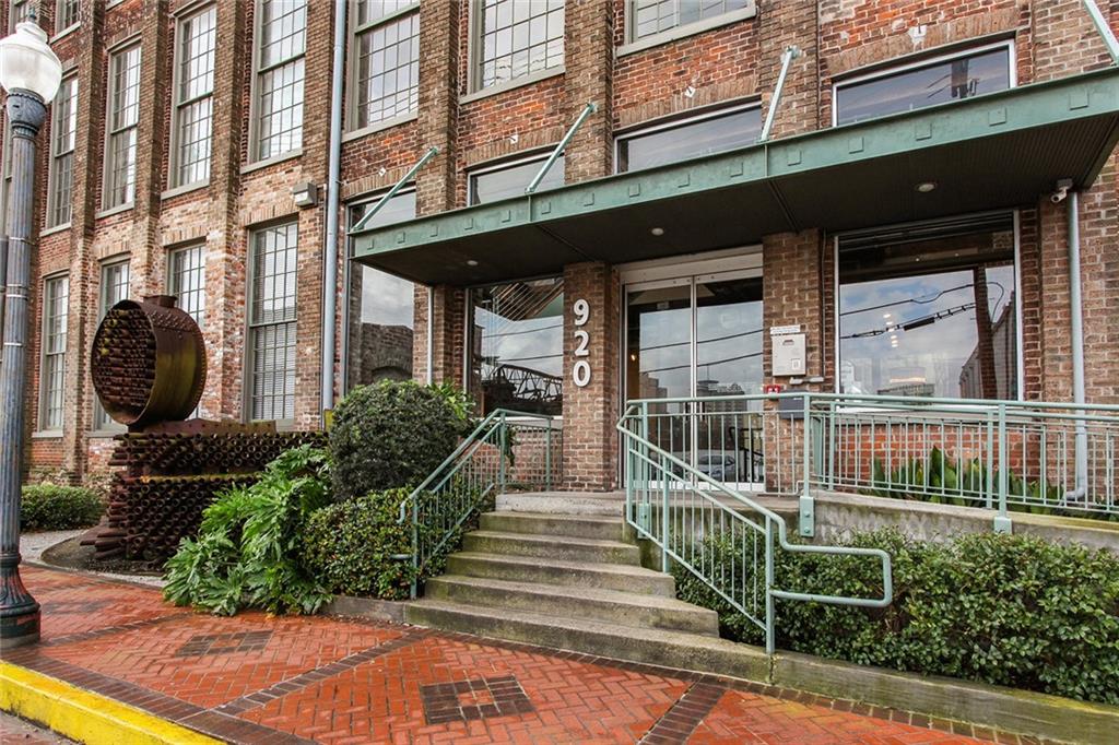LOCATION - COURTYARD VIEW - TWO BATHS - LOVELY, FLEXIBLE FLOOR PLAN. These words aptly describe this stunning Cotton Mill condominium. This floor plan allows for great flexibility, with a SECOND Bath downstairs in case you'd like to welcome guests to share all the fun of living in the HEART of the Warehouse District in this iconic building. The kitchen has stainless appliances, granite counters, massive windows overlooking a the courtyard just above the tree line for lovely views and gorgeous natural sunlight. The windows have brand new shades. The upstairs primary bedroom has TWO large walk-in closets. The building amenities abound with 24/7 concierge service, heated in-ground pool, state-of-the-art gym, massive courtyard that is meticulously maintained year round. The condo dues include so much - water (new tankless system installed in building last year), cable, Internet, pest control, termite contract, and common insurance from studs out. Contract parking available at Pelican Lot ($197/month approx). You'll love this unit!