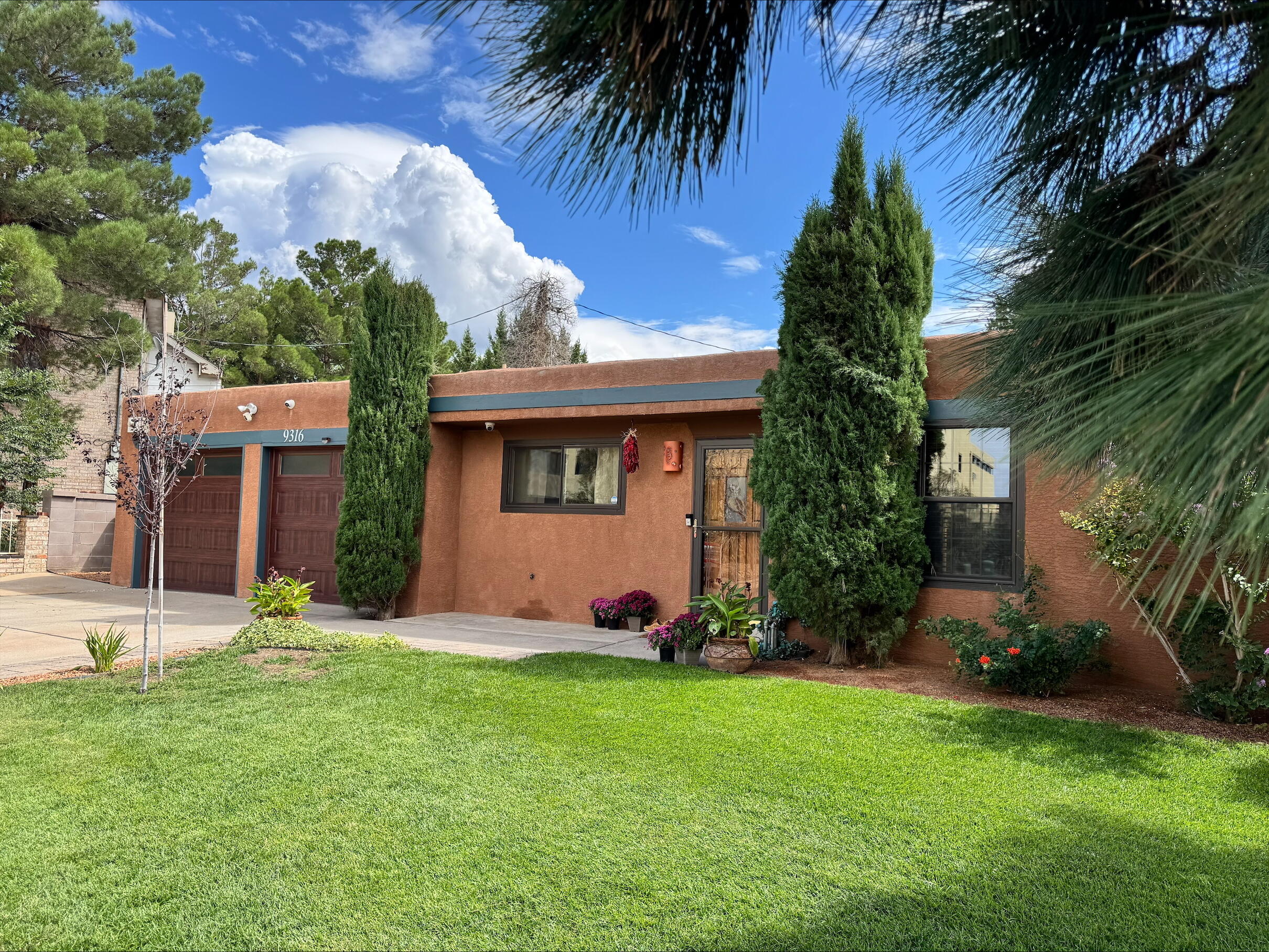 Discover this charming, updated Southwestern bungalow that seamlessly combines classic appeal with modern elegance. This single-story, one owner home, available for the first time, features 2 bedrooms, 2 bathrooms, 2 spacious living areas & 2 car garage. Interior showcases warm earth tones & natural finishes, highlighted by beautiful tile & bamboo wood floors & striking brick fireplace. The remodeled kitchen is equipped with stainless steel appliances and granite countertops, with premium details extending into both updated bathrooms for a cohesive, high-end aesthetic with a rustic New Mexico appeal.Step outside to your private outdoor oasis, featuring a wood pergola, custom stone-wrapped grill and bar, & a relaxing Jacuzzi. This space offers the ultimate in relaxation & tranquility.