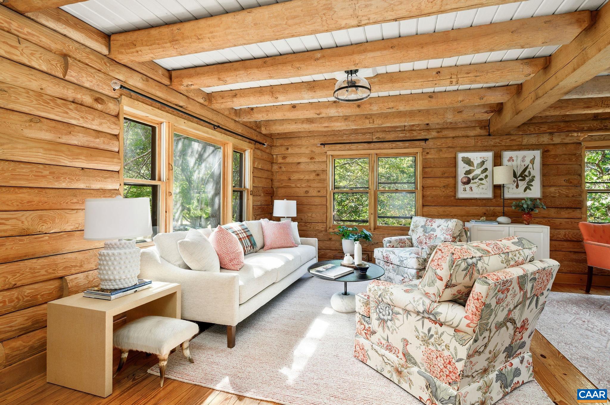 With many recent improvements, this charming log home lives like new while retaining its timeless character. The kitchen and baths have been beautifully renovated, hardwood floors freshly refinished and the interior painted, creating a move-in ready residence that feels bright and welcoming. Sited on two gently rolling acres, the property offers both privacy and convenience just under ten minutes to town and only minutes from Crossroads Shopping and Dr. Ho’s. A wide covered porch provides a perfect place to relax, while the rear deck extends the living space outdoors with pastoral views. Inside, the open floor plan is ideal for everyday living and entertaining. A cozy wood stove anchors the main living area, while the updated kitchen flows easily into the dining. With three bedrooms and two full baths, the home balances comfort with functionality. The unfinished lower level offers excellent possibilities for future expansion—whether for recreation, hobbies or guest space and includes an oversized two-car garage with storage. Blending thoughtful updates with classic log cabin charm, this home is a rare find.