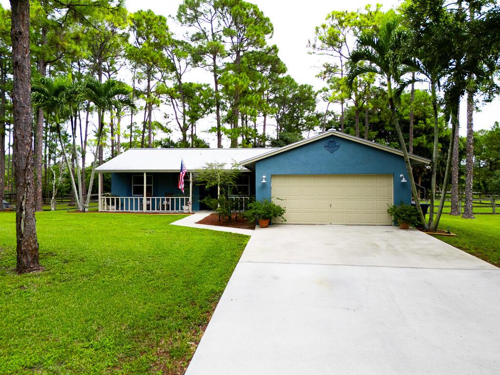 Enjoy country living at its finest!  This charming property is on a paved road and features 3 bedrooms and 2 bathrooms in a spacious 1,280 sq ft layout on a sprawling 1.37-acre lot. This home features a METAL roof was installed in 2018, and Royal exterior Walls. You'll absolutely love the farm-style covered porch that greets you.  Inside, notice the elevated ceilings and tile floors throughout, complemented by neutral colors that invite personal touches. The well-appointed kitchen boasts a large eat-in area with new stainless steel appliances, abundant countertop space, and recessed lighting, making it perfect for entertaining. The master bedroom offers a spacious retreat with walk in closet, an updated bathroom featuring a walk-in shower and shower seat. Laundry space in the OVERSIZED deep garage is equipped with a NEW washer and dryer for added convenience, and tankless water heater. Step outside to your private oasis, featuring a fully fenced backyard with beautiful landscaping, oversized driveway, and a covered patio with pavers installed in 2022. Enjoy the swim spa (15x8x5) with jets and seating, plus a water hookup for an outdoor bar or kitchen. Additional highlights include, a detached shed (10x20) with a roll-up door, and a detached car canopy with electric and water access. For animal lovers, the barn (24x36) includes up to 3 stalls, electricity, and water, along with a paddock for farm animals. Outdoors, you will also find flood lights, and a sprinkler system around the home. Schedule your showing today!