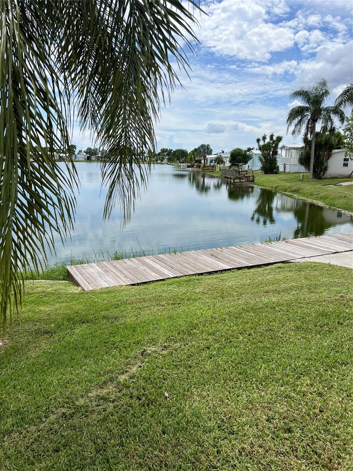 Welcome to Oasis Village- A 55+ Community. This beautifully maintained 2 Bedroom 2 Bath, furnished home is comfort ready! Spacious master suite with walk-in closet. Large outside utility room for extra storage. Double carport for plenty of parking. Relax and enjoy the water with your own dock. Perfect for year-round living or a seasonal retreat, this home has everything you need to enjoy the Florida lifestyle. Community amenities include a Beautiful clubhouse heated pool for year-round relaxation. Pickleball courts and billiards for active living. Covered mailboxes for added convenience. Located minutes from public boat ramps, close to shopping, and only 30 minutes from Brighton Bay Casino, you'll enjoy the best of both relaxation and recreation.