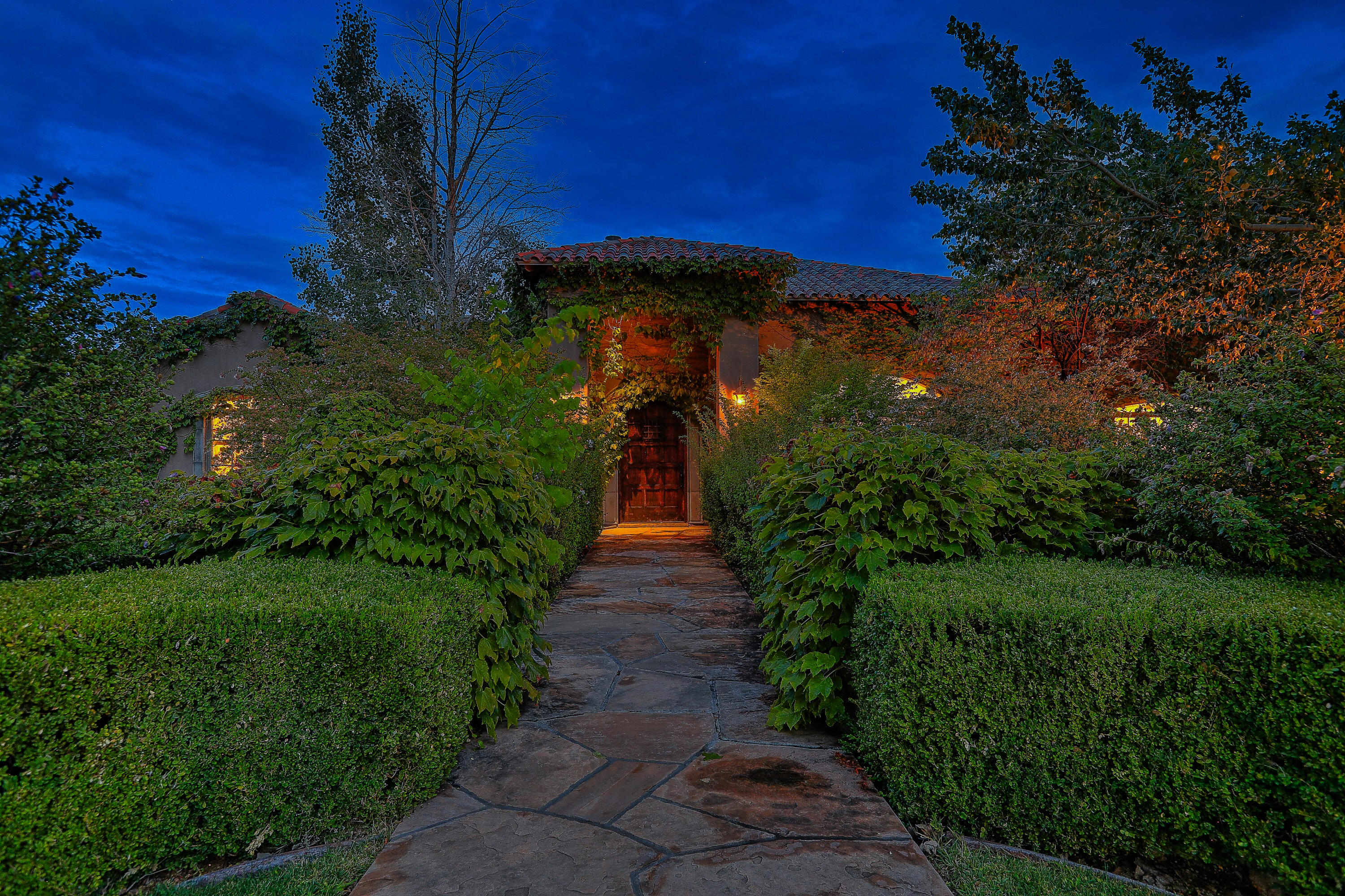 Exquisite North Valley Estate!Nestled on two lush green acres in the prestigious North Valley, this idyllic estate offers the perfect blend of elegance, privacy, and modern comfort. Built in 2006, the single-level residence spans 5,136 sq. ft. and showcases vintage hardwood floors, a spacious chef's kitchen with an expansive granite island, and multiple living spaces including formal living and dining rooms, plus a family/media room with tiered seating.The home offers four generously sized bedrooms, each with its own en suite bath, as well as a private executive office, gym, and flexible guest accommodations.