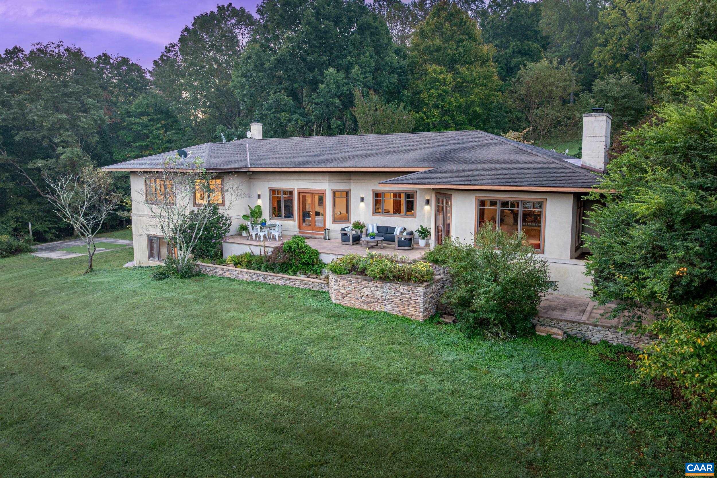 OPEN HOUSE SUNDAY, 11/2, 2:00-4:00 PM! Set against the backdrop of Yellow Mountain, this tucked away 24-acre sanctuary offers the ultimate blend of elegance and convenience. Just minutes from Crozet and Charlottesville, this custom built residence was designed by architect Dawn Rowe to frame SWEEPING YEAR-ROUND MOUNTAIN VIEWS and is crafted with gorgeous cherry woodwork, built-ins and cabinetry coupled with refined architectural details and an outstanding floor plan. Blue Ridge views from every Western facing window! MAIN LEVEL LIVING with versatile spaces including dedicated home office and terrace-level guest quarters with private entrance, rec room, 2 bedrooms and baths, kitchenette plus fabulous storage. Ideally set up for 2+ generations. Quiet, efficient geo-thermal HVAC system. Expansive invisible fence. Approximately 1/3 of the acreage is open. Glorious patio with soothing water feature, elevated fire pit area and stream-fed pond create an idyllic setting for entertaining, recharging and making memories. Whether hosting weekend gatherings or enjoying the region’s wineries, hiking trails or sporting events, this estate embodies the VERY BEST of Western Albemarle. See documents for full list of features and improvements.