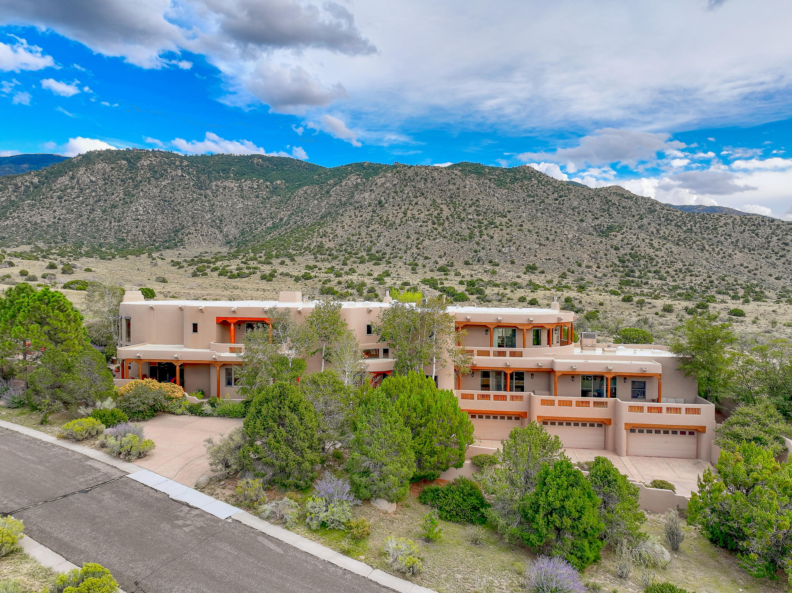 This spectacular custom home offers an extraordinary living experience on almost two acres with direct access to the National Forest.  The dramatic living room is the home's centerpiece with soaring ceilings and a wall of windows that frame the breathtaking desert and mountain scenery. This expansive space also includes a gourmet kitchen, formal dining room and a dedicated bar. The luxurious primary suite features a sitting room, fireplace, his-and-hers bathrooms, and a private city-view deck. In addition a secluded guest suite offers a sitting room and two ensuite bedrooms. The expansive loft area features a wet bar and a separate family room.The home also includes a large gym and an incredible 8-10 car garage. Numerous outdoor patios/balconies complete this stunning sanctuary.