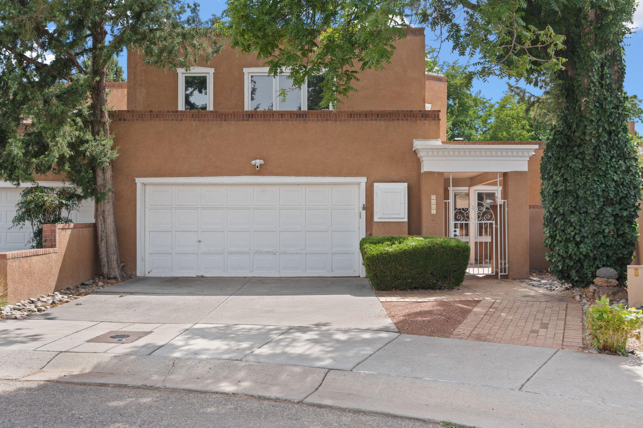 Tucked in the heart of Albuquerque's charming North Valley, this spacious territorial-style townhome offers comfort, character, and unbeatable access to the city's best amenities. Spanning an impressive 3,074 sq ft, this spacious home features 3 bedrooms, 2.5 bathrooms, and a versatile loft. The thoughtfully designed floor plan includes two inviting living areas, each with its own striking fireplace. Formal dining room, eat-in kitchen,  generous kitchen island with bar seating provide multiple dining options for family and guests. main floor includes a roomy bedroom and a convenient 3/4 bath! Upstairs find the large loft perfect for a home office. Owners suite with private bath! New paint and carpet ! TPO roof and skylights replaced in 2021! Near Old Town and the Saw Mill District!