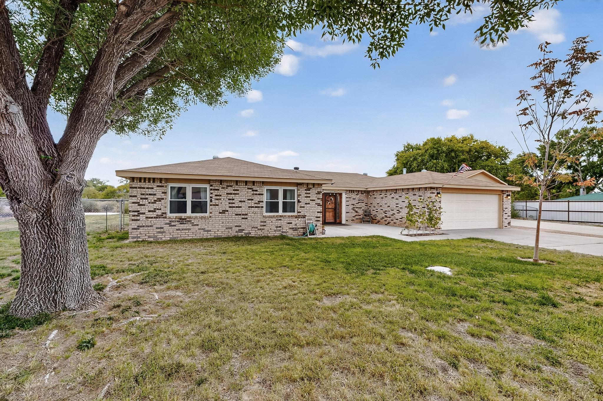 This beautifully updated South Valley home offers 4 bedrooms, 2 bathrooms, and thoughtful upgrades throughout. Enjoy a fully remodeled kitchen with a large island, modern bathrooms, and newer LVT flooring. Exposed wood beams in the living room add warmth and character, while the open floor plan makes the home feel inviting and spacious.Set on a 1/2-acre lot, the property opens to 11 acres of APS-owned land, providing a sense of privacy and open space. Outdoor amenities include a covered patio, mature trees, and a covered RV port with electricity and a sewer cleanout. A 2-car garage adds convenience, and as a unique touch, a decorative metal sculpture adds personality to the yard.This South Valley gem blends modern comfort with space to stretch out -- a perfect place to call home.