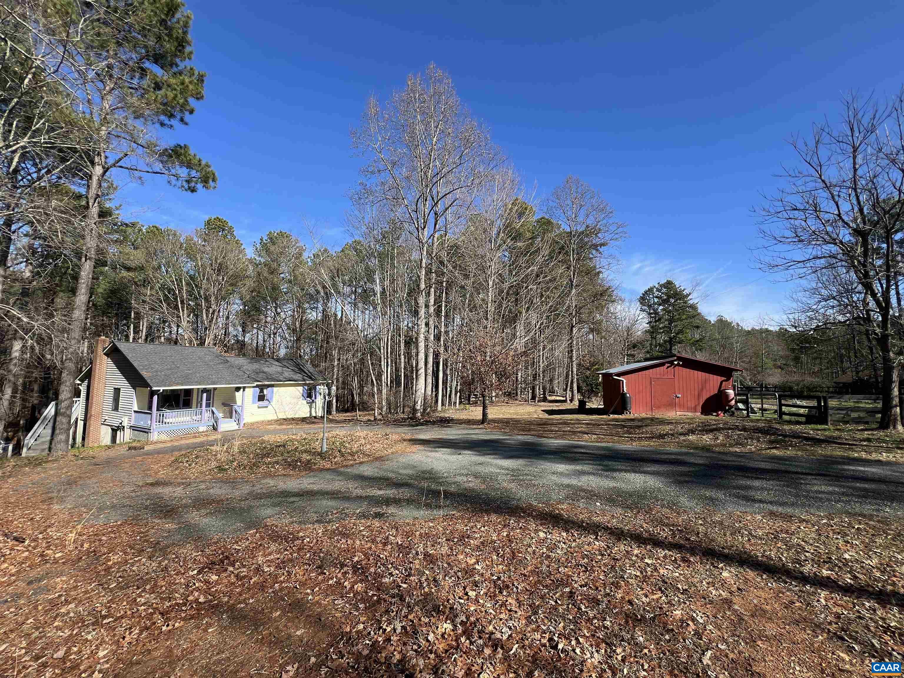 5 acres of unlimited potential with multiple outdoor shelters, farmette with multiple fenced areas for horses and all types of animals, stream, garden spots and more. Great horse property in desirable Albemarle County location.  Rustic home with vaulted ceilings with open concept living room with beautiful fireplace, hearth and private wooded views. Open concept between living room, dining room and kitchen.  Hardwood floors throughout.  Large primary suite with custom shower.  Large rear deck great for relaxation and entertaining.  Terrace level features a large recreation area with wonderful built-ins and wood stove.  Home office, two large bedrooms and a full bath on terrace level as well.  Large storage shed/workshop spaces with electric. Must see this one in person to truly appreciate.  3D and full motion videos available by request.