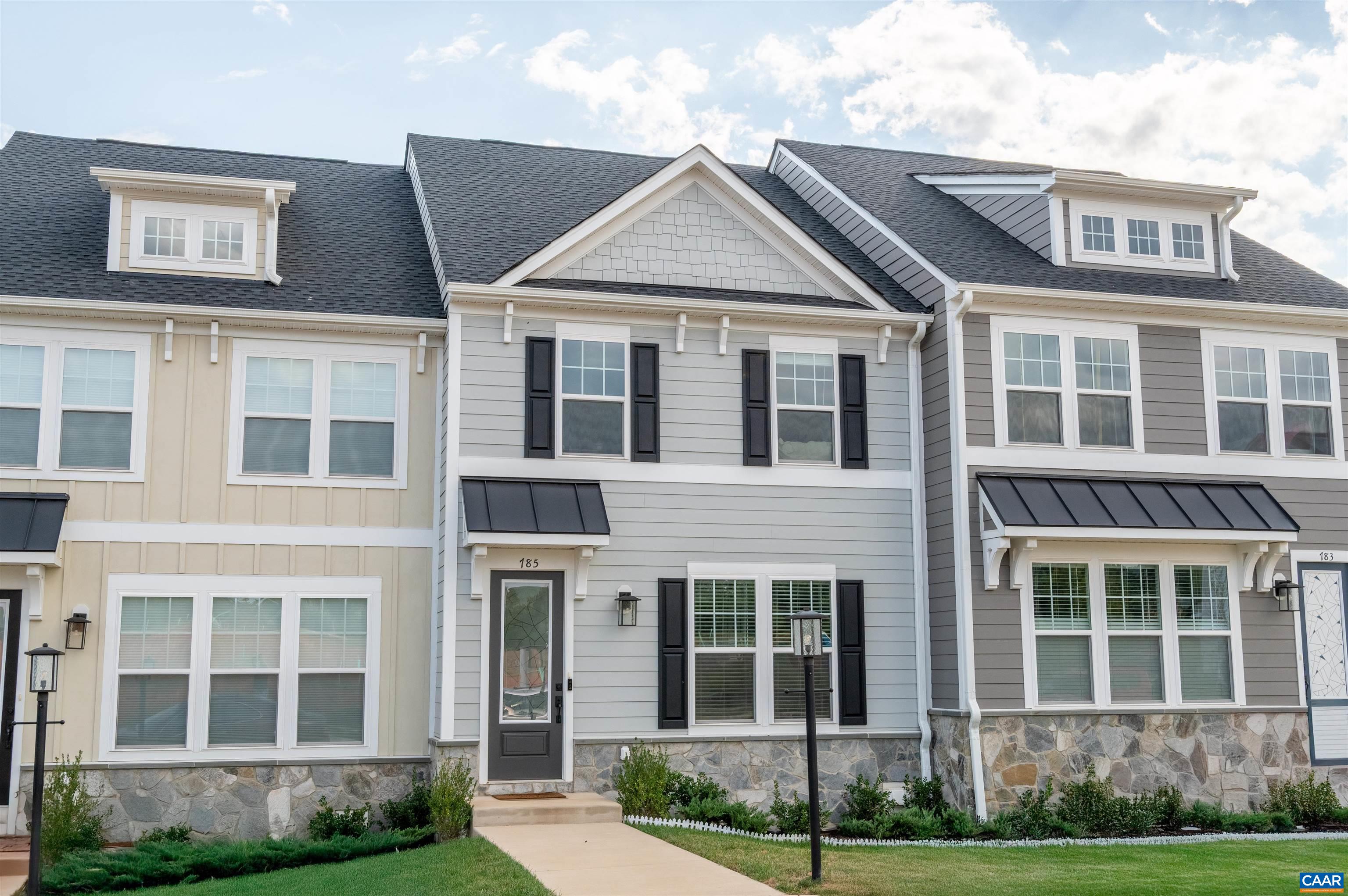 New construction without the wait! This virtually-new, move-in ready townhome, built by Greenwood Homes, offers a scenic setting with Blue Ridge Mountain views, parks, and walking trails just minutes from downtown Crozet and Western Albemarle Schools. This eco-friendly, low-maintenance farmhouse-style home offers two stories plus a basement with a rec room—ideal for an office, playroom, or gym—and a rear-entry 2-car garage. The main level boasts hardwood flooring throughout the main areas and an open layout with a spacious modern kitchen, oversized granite island, white cabinets, walk-in pantry, and stainless steel appliances. Upstairs, you'll find the spacious primary suite, two additional bedrooms, a full hall bath, & a convenient laundry area. Features include dual vanities, a frameless glass shower, oak stairs, solid core doors, wood shelving, upgraded trim, spacious back deck and an energy-efficient furnace. Enjoy easy access to Crozet Park via a walking path and direct community access to downtown Crozet. A short drive to I-64 & 250 Access, 25 minutes to Downtown Charlottesville and UVA. The Glenbrook community offers green spaces, tot lots and community firepits, providing ample opportunities to stay active and connected!